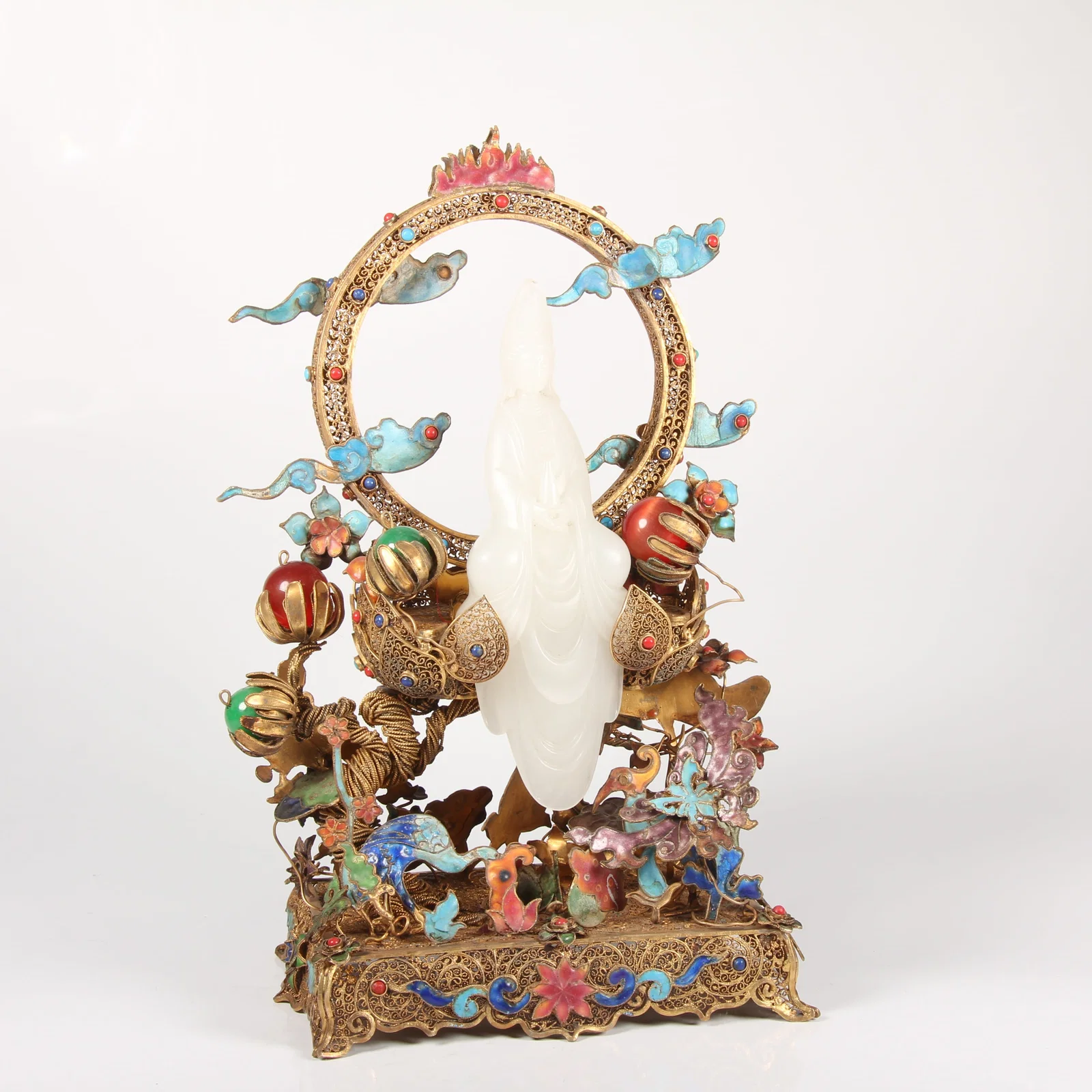 A HETIAN WHITE JADE GUANYIN STATUE WITH SILVER FILIGREE, GILT, AND CLOISONNÉ-ENAMEL BASE