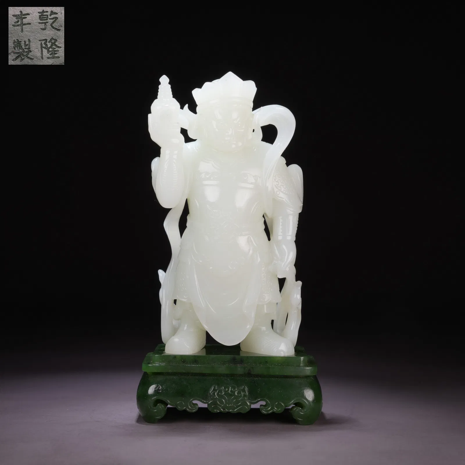 A HETIAN WHITE JADE HEAVENLY KING HOLDING A PAGODA WITH INLAID GREEN-JADE BASE