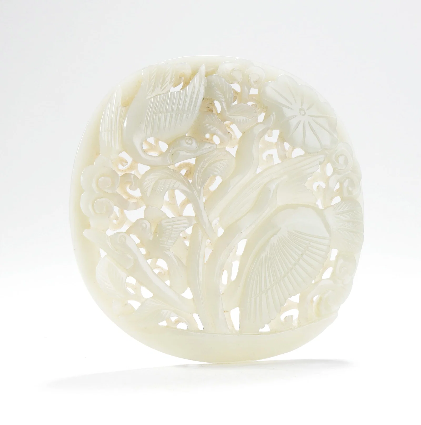 A HETIAN WHITE JADE OPENWORK ROUND PLAQUE WITH BIRD AND FLOWER PATTERN