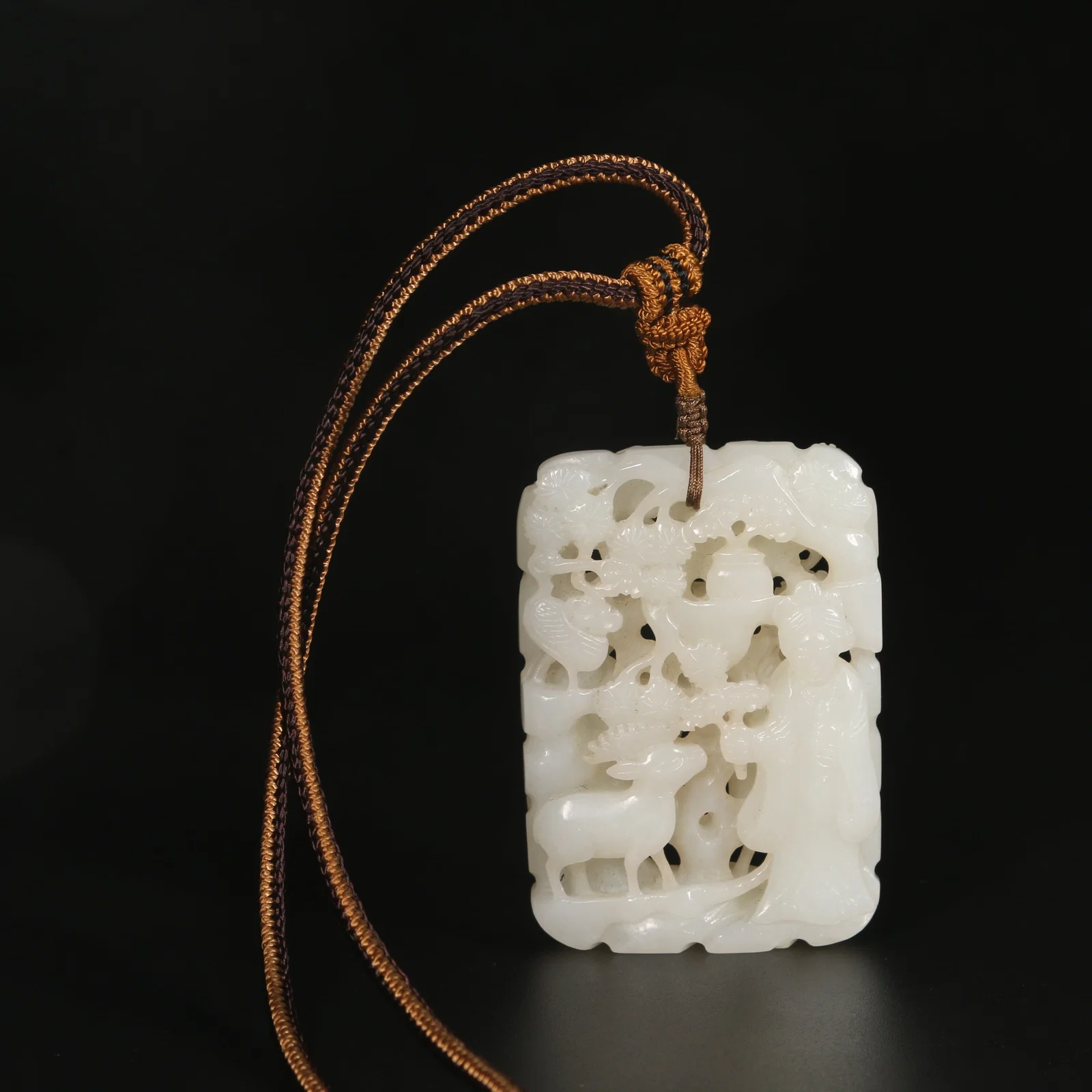 A HETIAN WHITE JADE PENDANT WITH CRANE AND DEER SYMBOLIZING LONGEVITY
