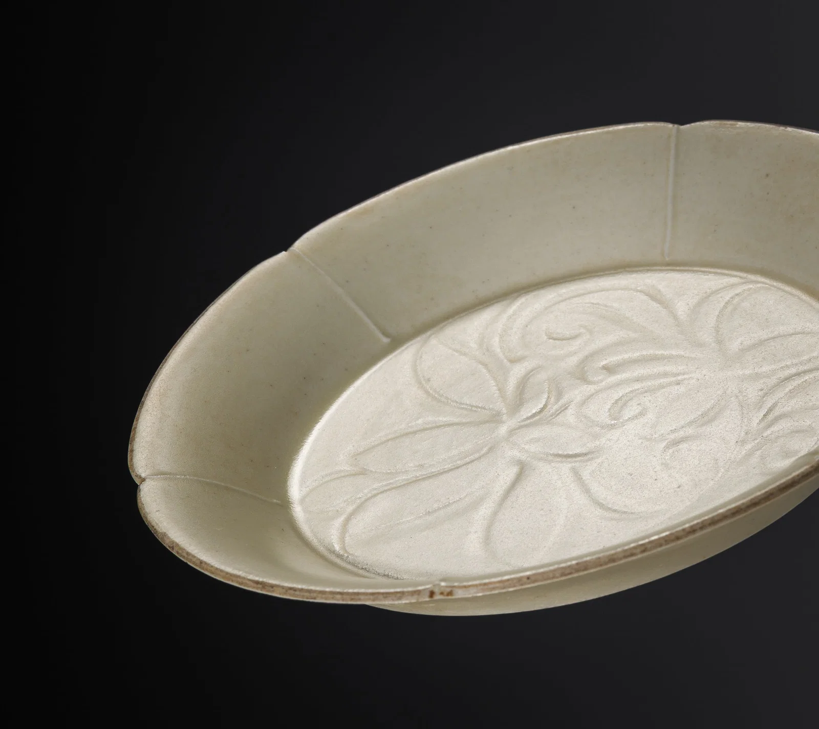 A HEXALOBED AND CARVED DING 'LOTUS' DISH, NORTHERN SONG TO JIN DYNASTY