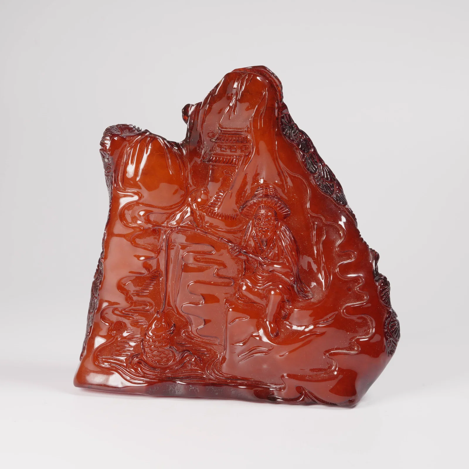 A HONEY-AMBER MOUNTAIN ORNAMENT WITH JIANG TAIGONG FISHING SCENE