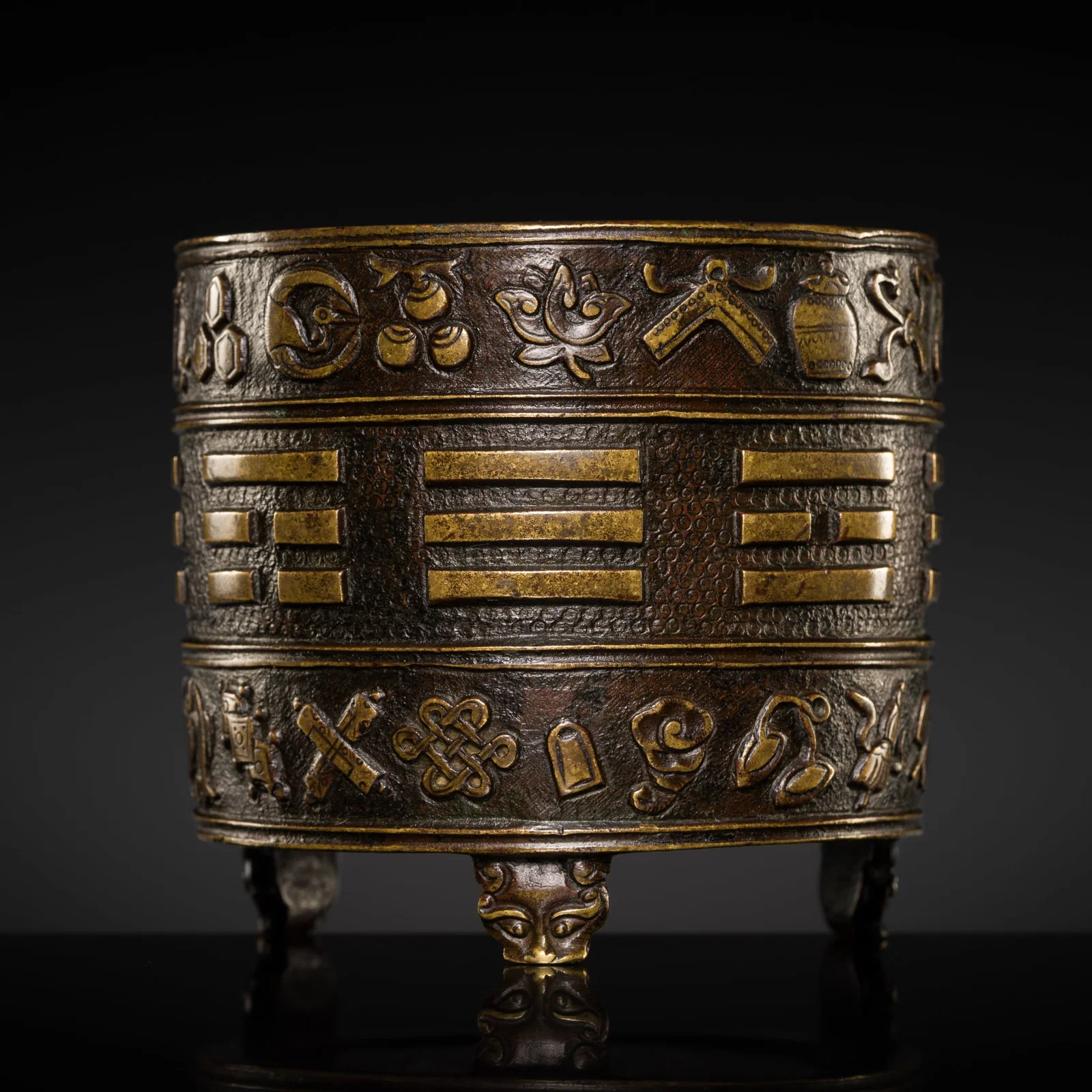 A HU WENMING PARCEL-GILT BRONZE 'BA GUA' TRIPOD CENSER, 17TH CENTURY