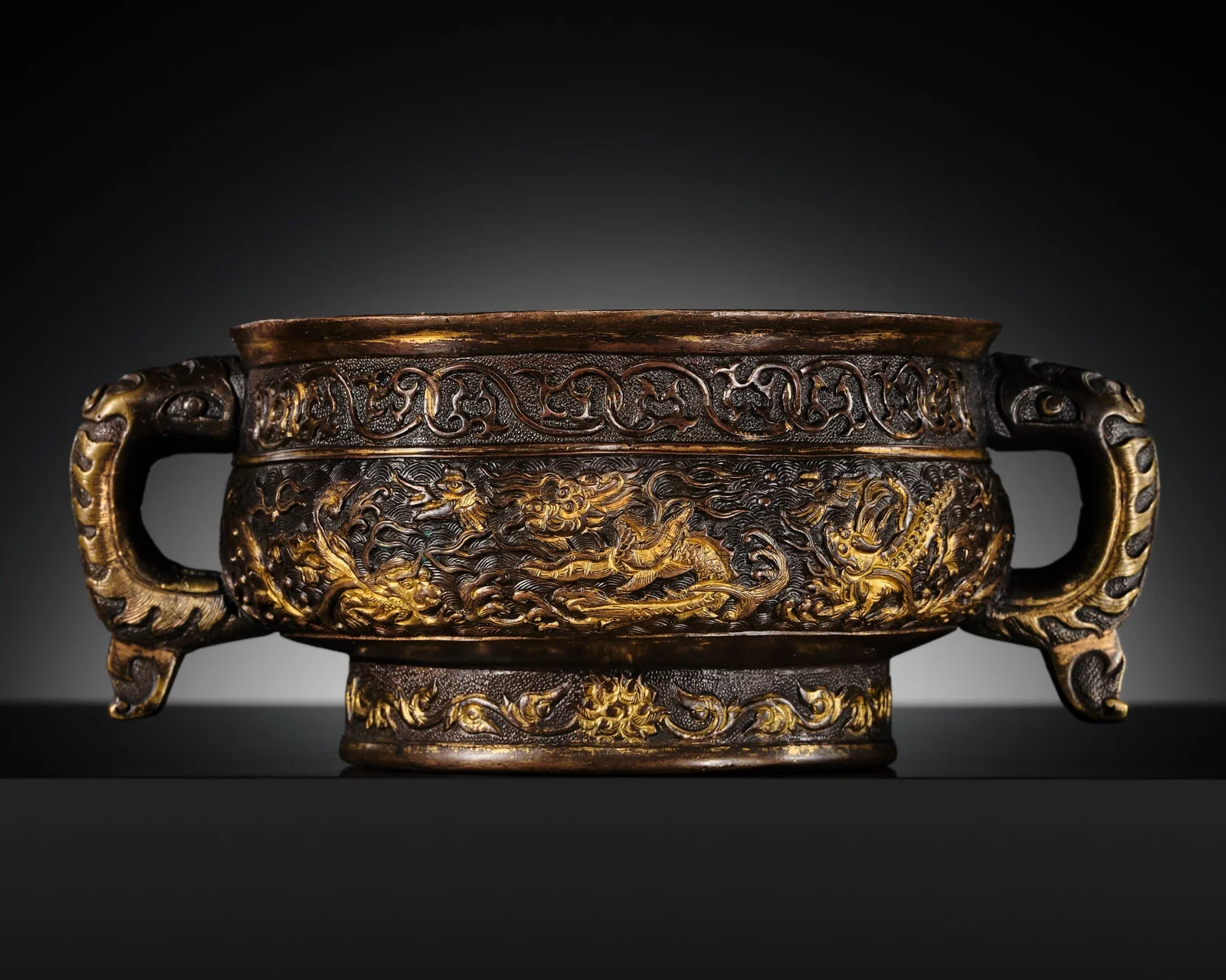 A HU WENMING PARCEL-GILT BRONZE CENSER WITH A FEIYU (FLYING FISH-DRAGON), MING DYNASTY