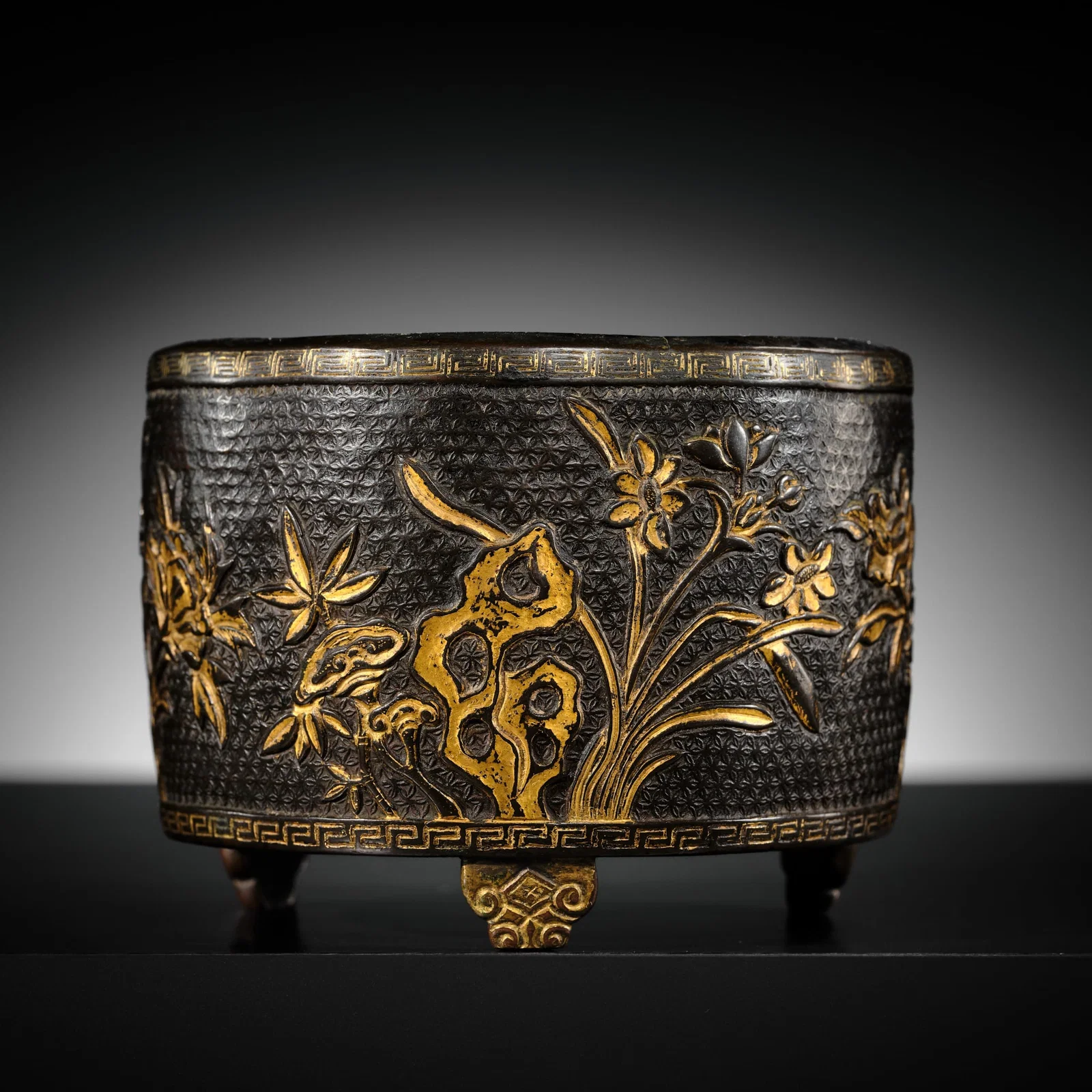 A HU WENMING PARCEL-GILT 'LINGZHI & LOTUS' BRONZE TRIPOD CENSER, MING DYNASTY
