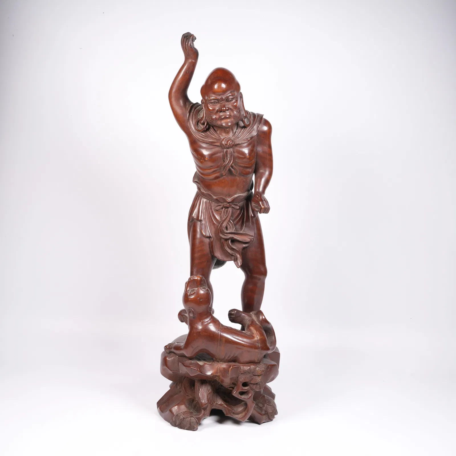 A HUANGHUALI RECLINING TIGER ARHAT FIGURINE