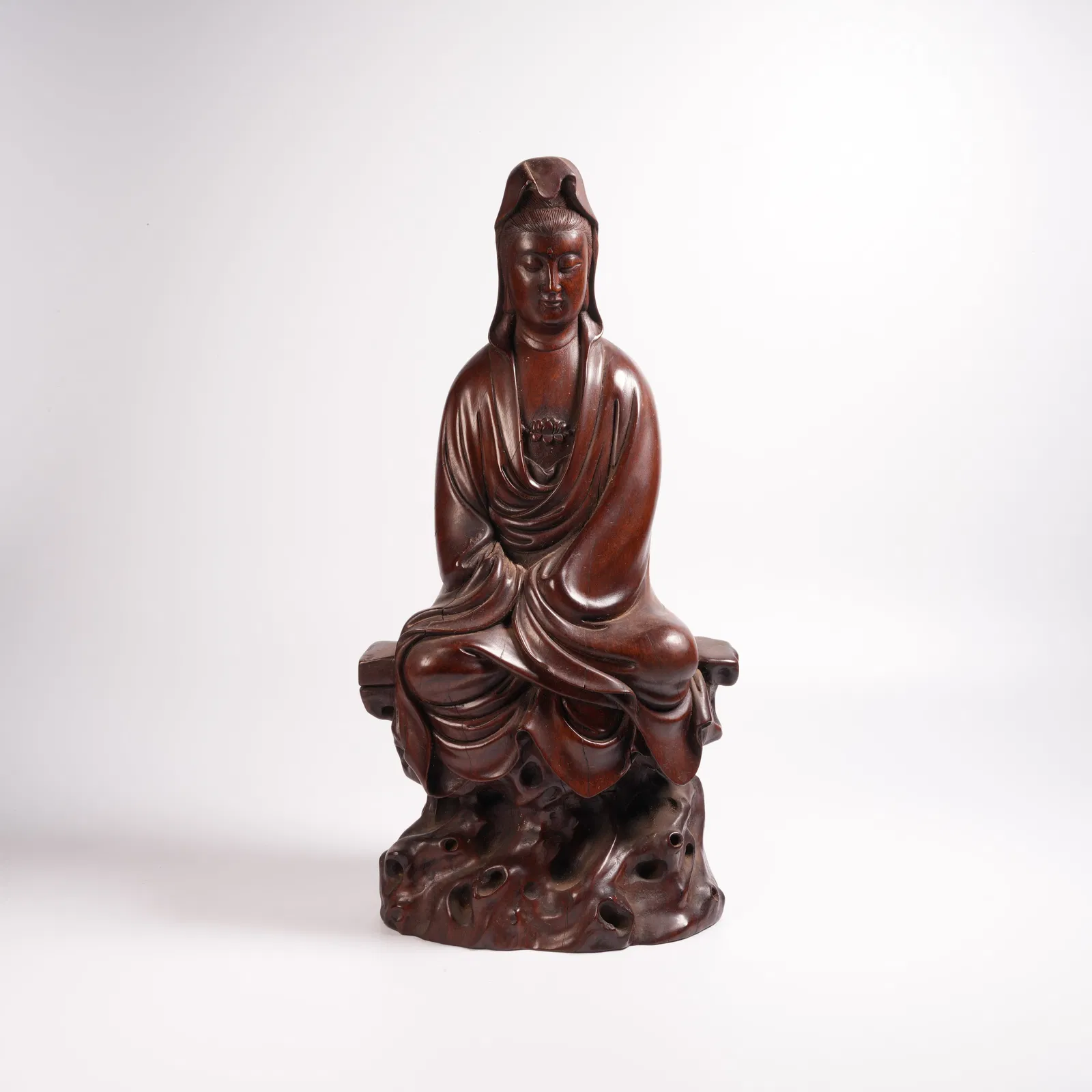 A HUANGHUALI SEATED GUANYIN STATUE