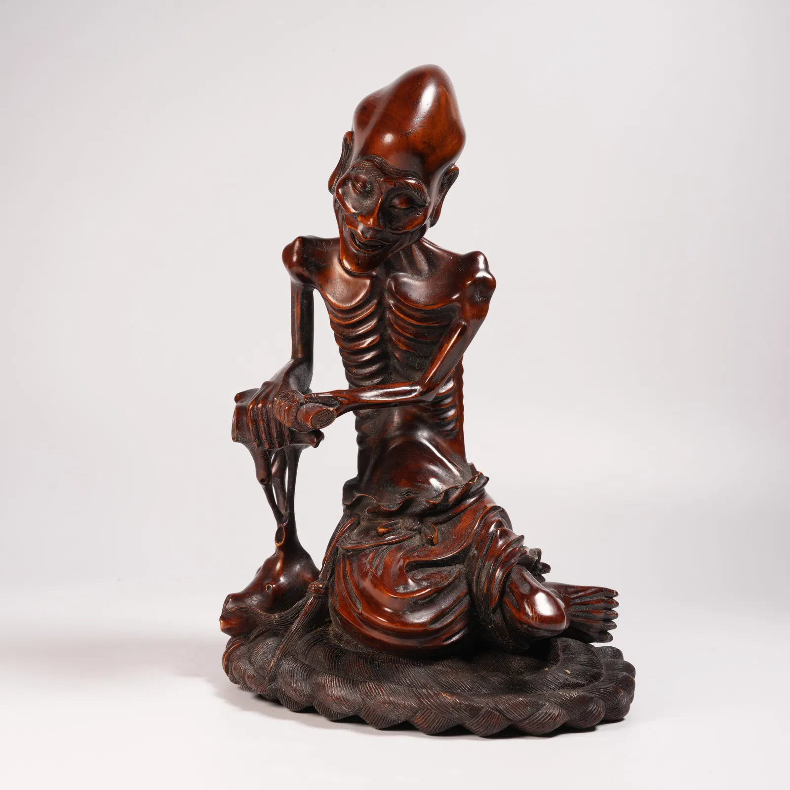 A HUANGHUALI SLENDER-ARHAT FIGURINE