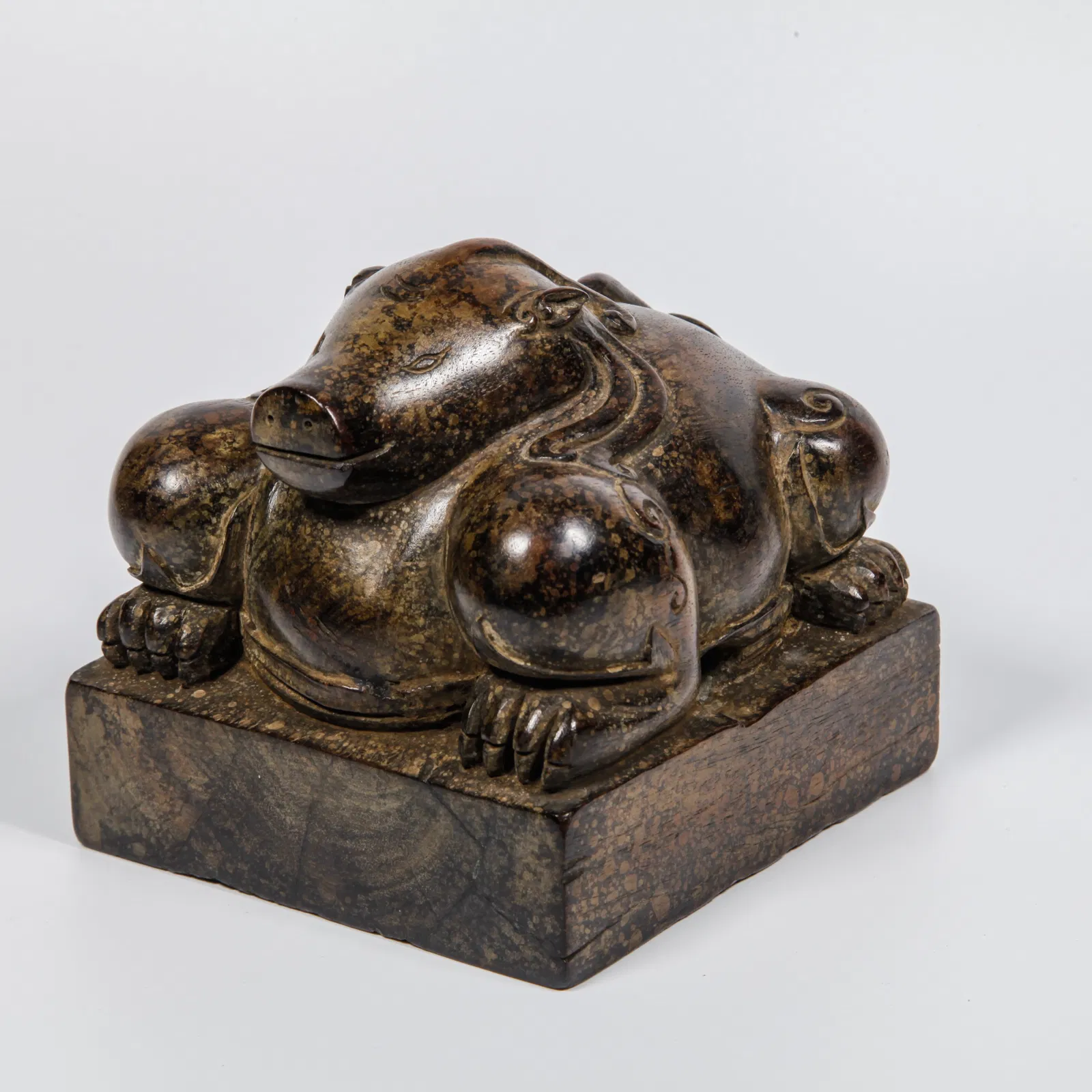 A HUANGHUALI WOOD CARVED AUSPICIOUS BEAST-HEAD SEAL