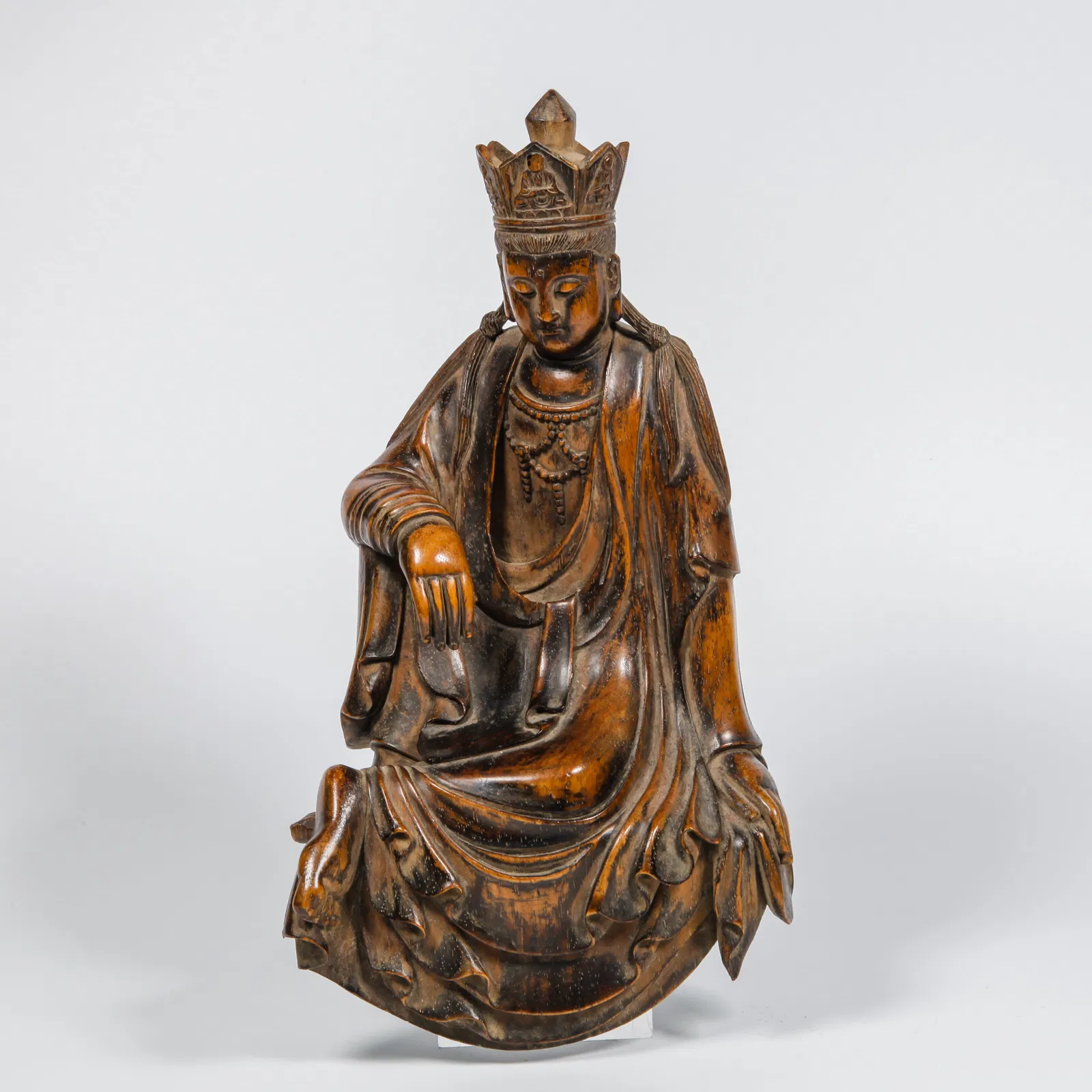 A HUANGHUALI WOOD CARVED FIGURATIVE ORNAMENT