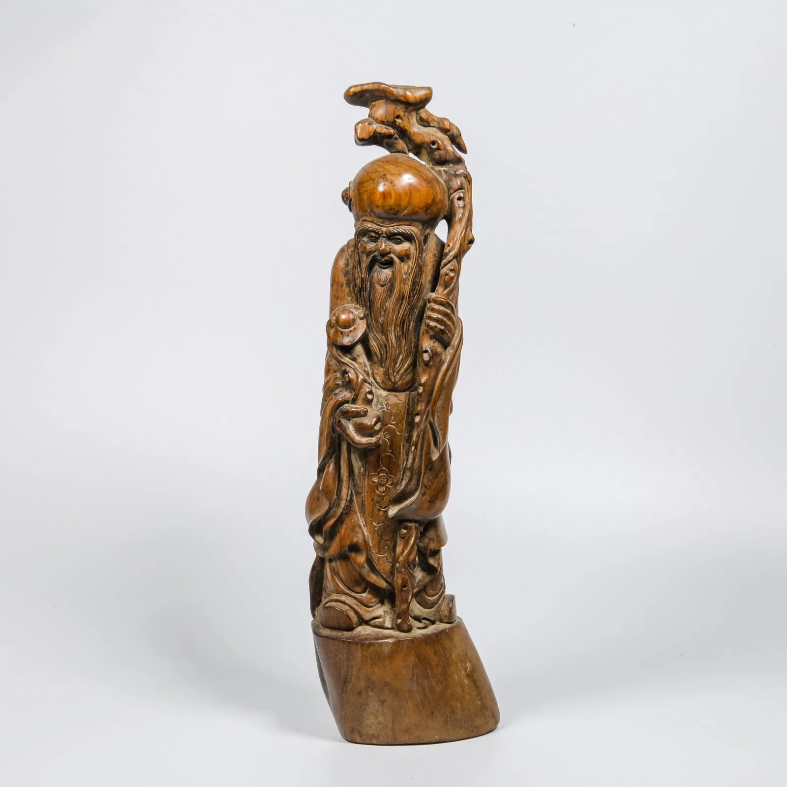 A HUANGHUALI WOOD CARVED LONGEVITY STAR ORNAMENT