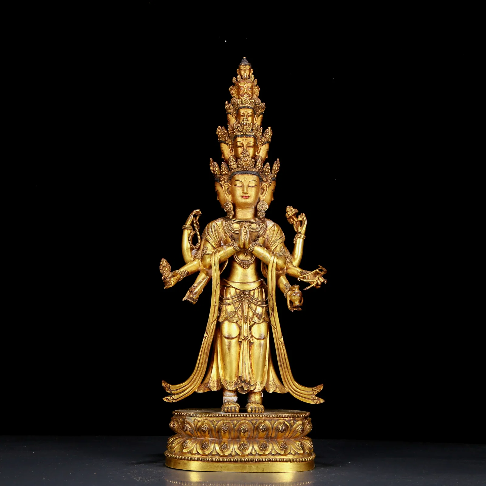 A huge gilt bronze statue of Guanyin with eleven faces