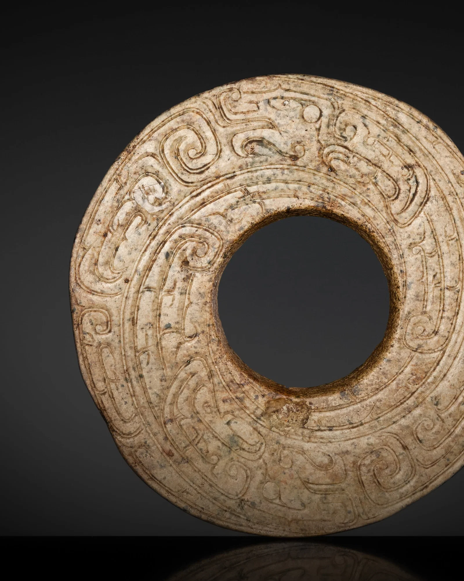 A JADE 'DRAGON' DISK, HUAN, WESTERN ZHOU DYNASTY