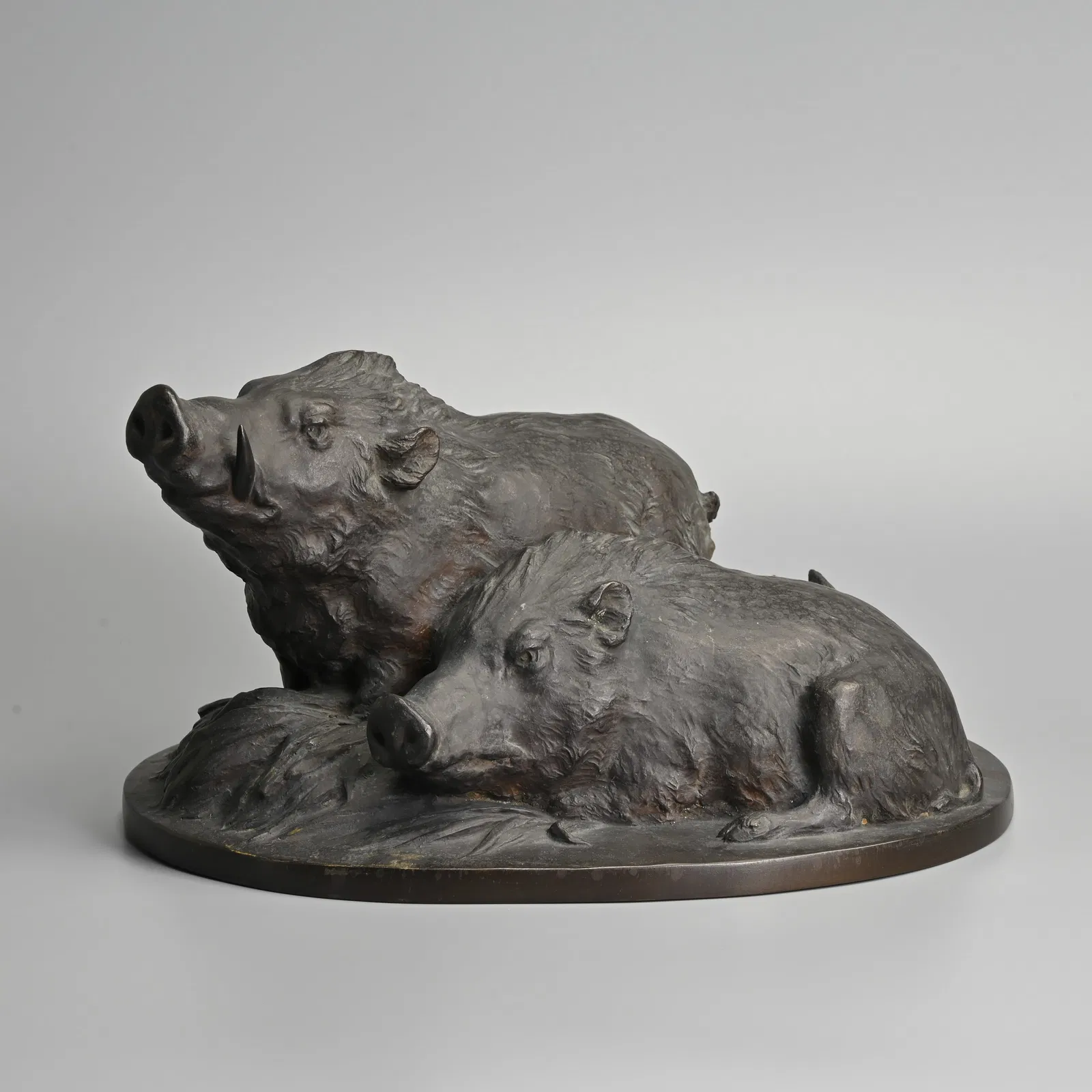 A JAPANESE BRONZE MODEL OF TWO BOARS BY SOGAN SAITO (1889-1974).