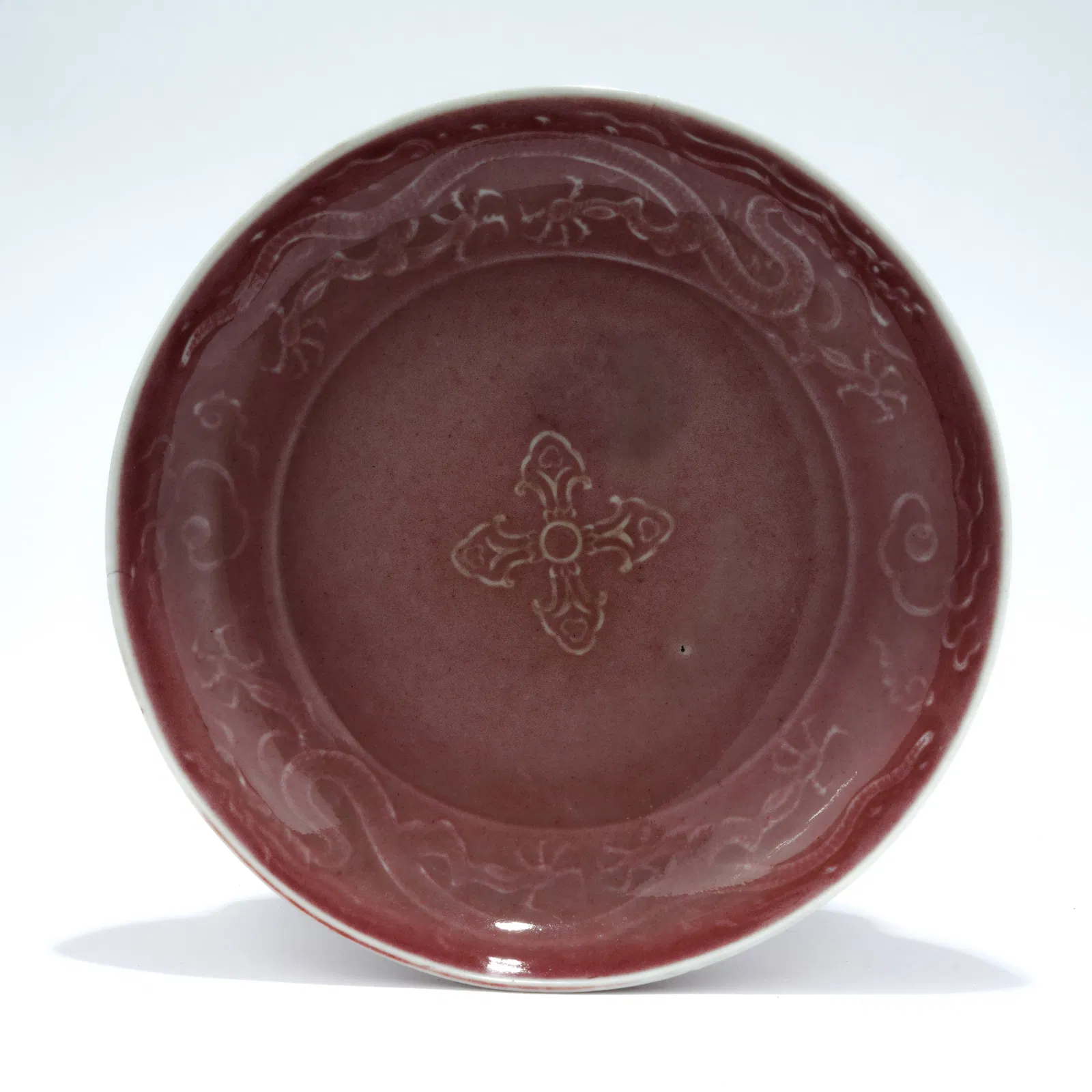 A KIDNEY-BEAN RED GLAZED DISH WITH INCISED DRAGON DESIGN