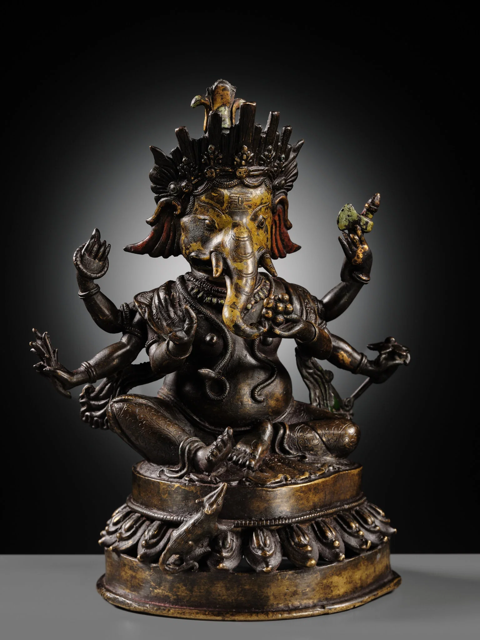 A LACQUERED COPPER ALLOY FIGURE OF GANESHA, 18TH-19TH CENTURY
