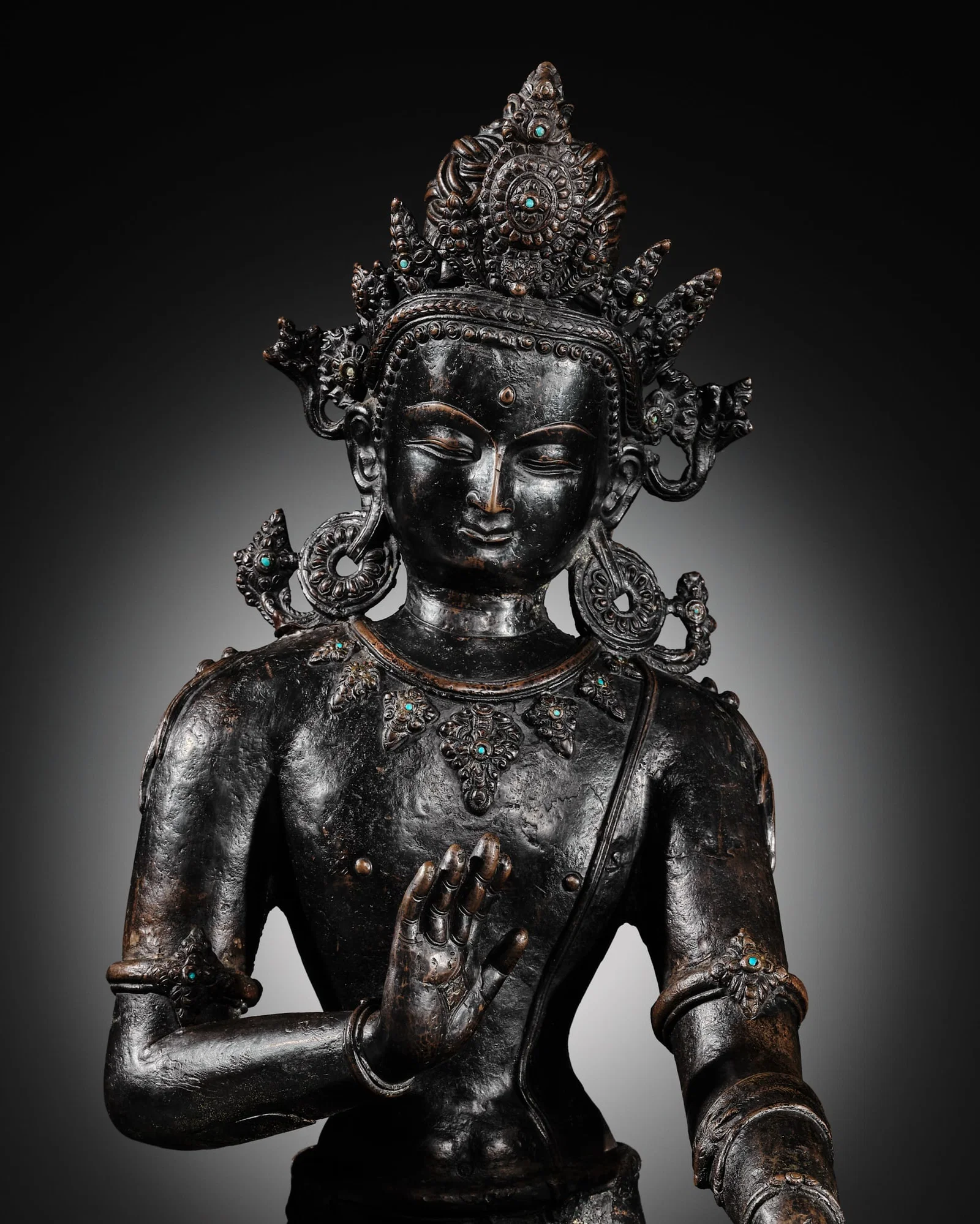 A LARGE AND IMPORTANT TURQUOISE-INLAID BRONZE FIGURE OF AVALOKITESHVARA, NEPAL, 14TH CENTURY