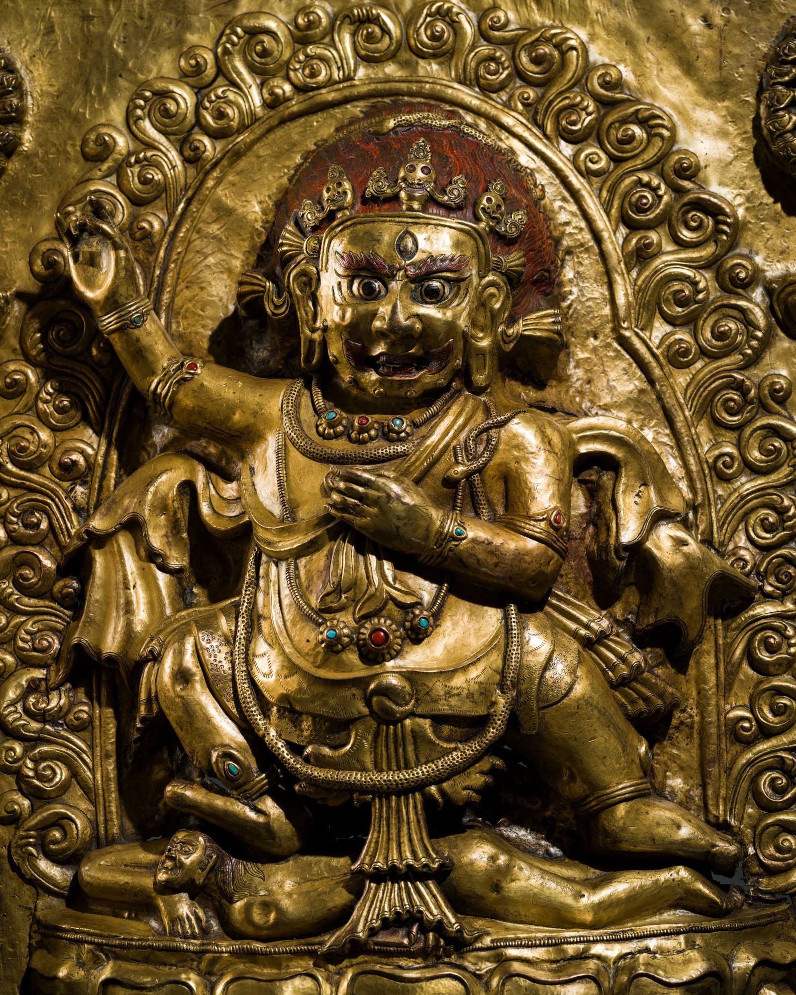 A LARGE GILT COPPER ALLOY REPOUSSÉ PANEL OF VAJRAPANI AND RETINUE, TIBET, CIRCA 17TH-18TH