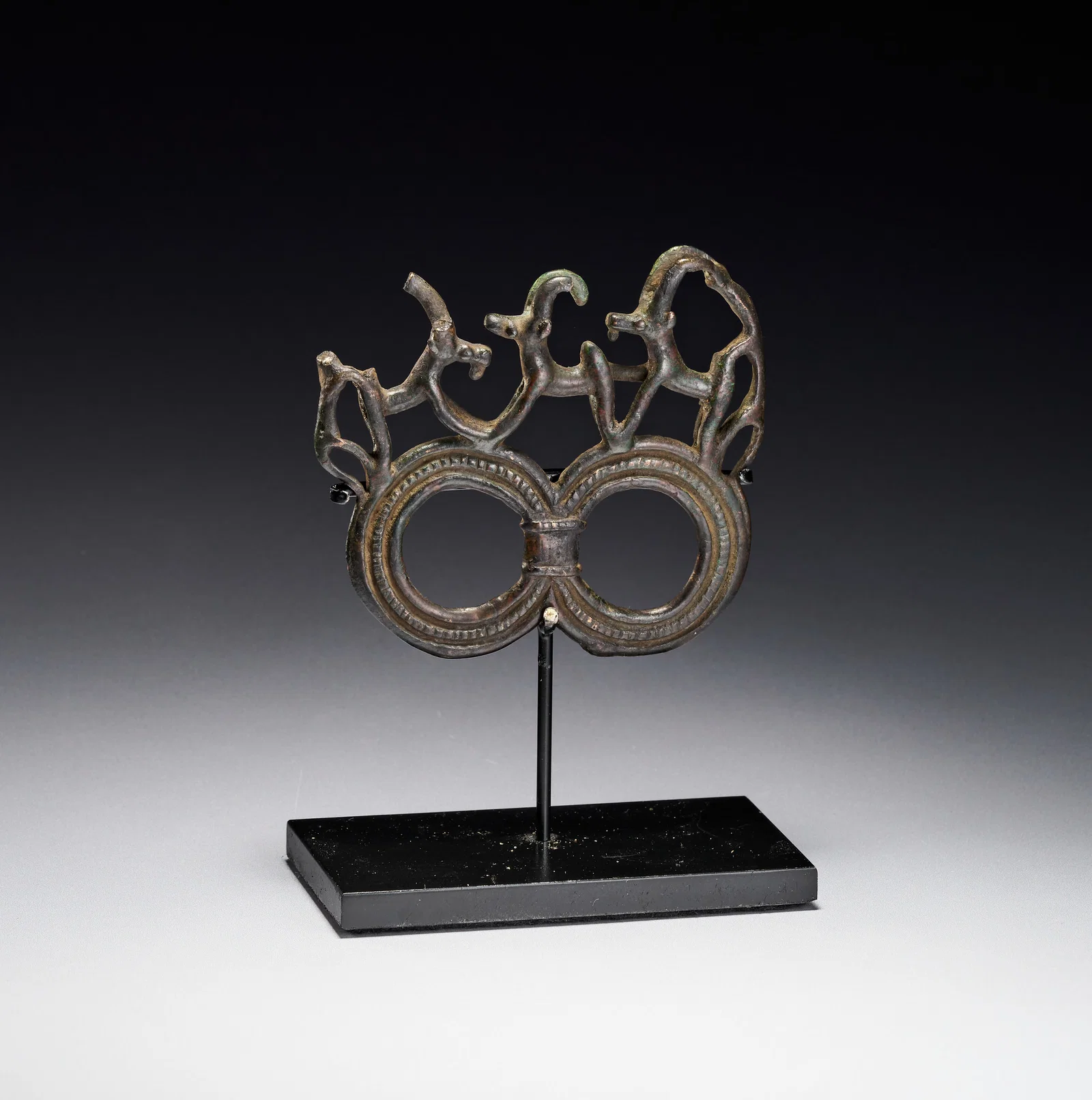 A LURISTAN BRONZE HARNESS FITTING, 900 BCE - 700 CE
