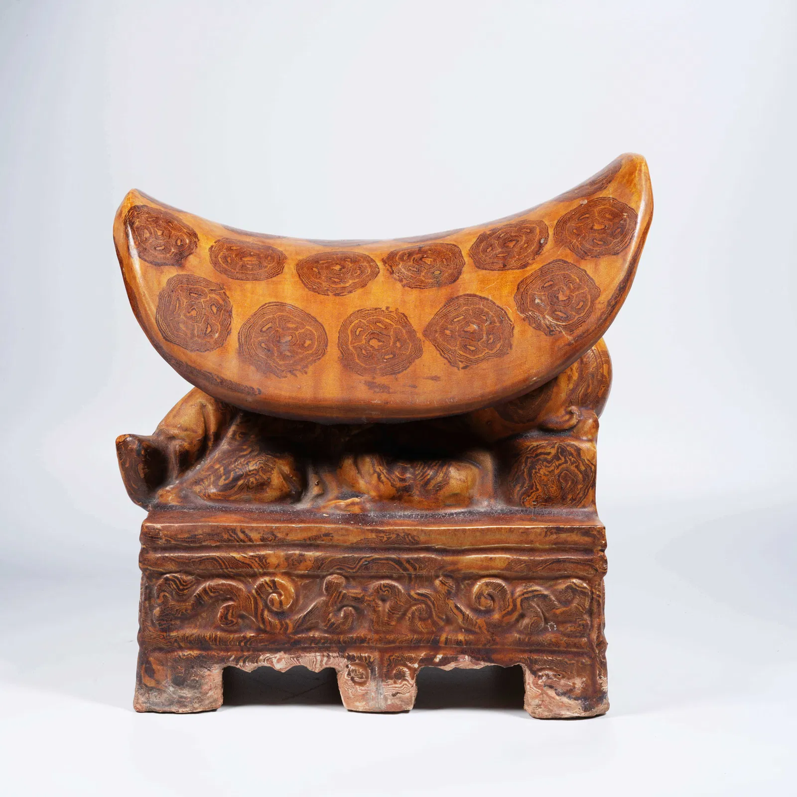 A MARBLED CLAY PILLOW WITH BOY MOTIF