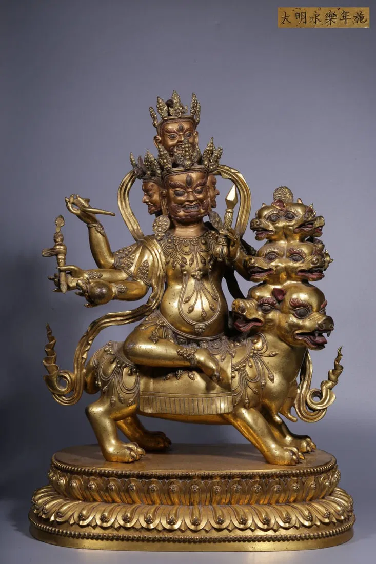 A MING DYNASTY GILT BRONZE SIX-ARMED MAHAKALA STATUE