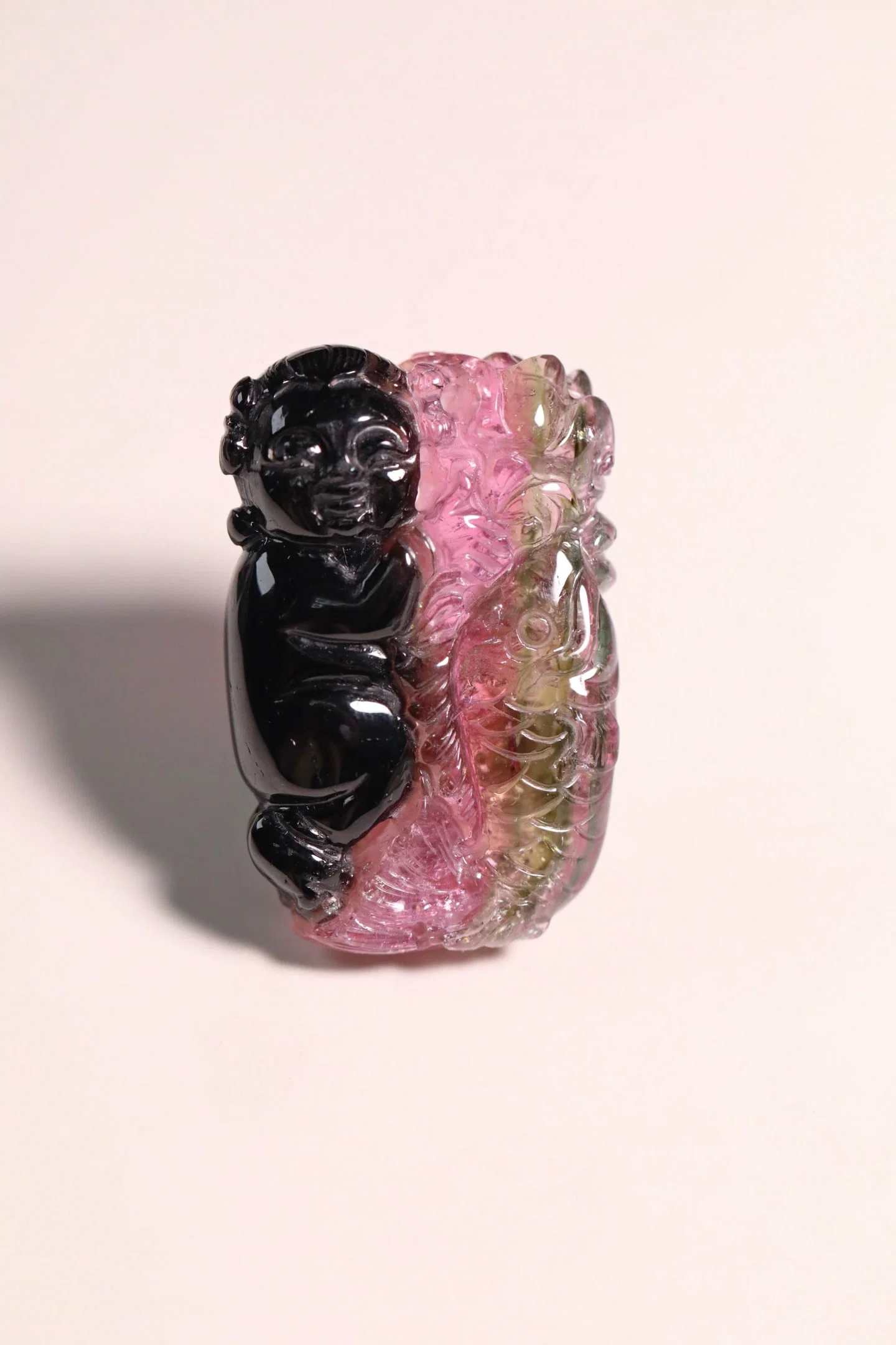 A natural glue-free two-color tourmaline boy holds a lotus pendant every year