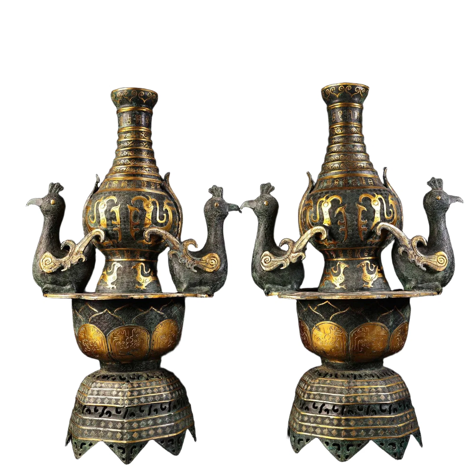 A pair of bronze candlesticks with gold inlay.