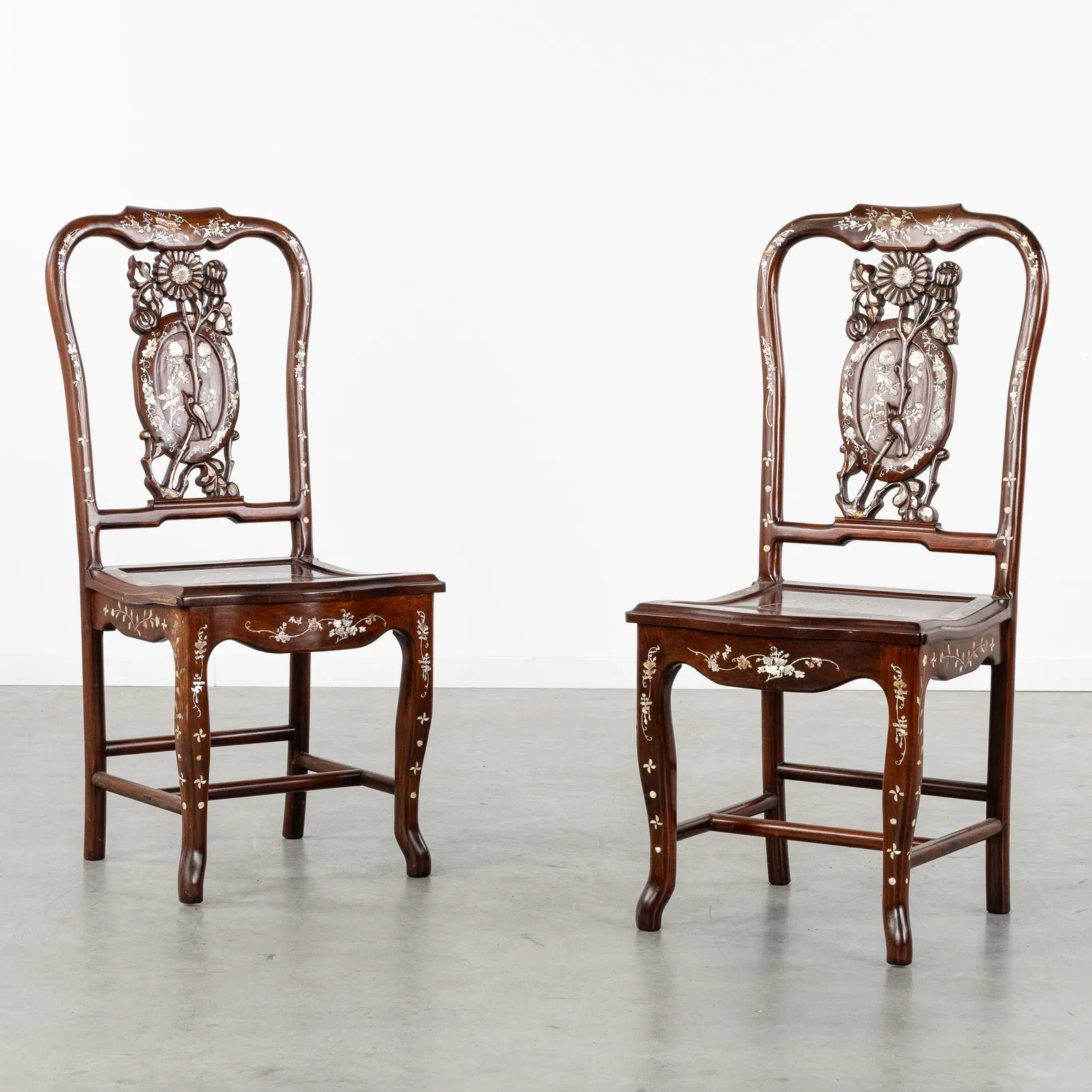 A Pair of Chinese chairs, Sculptured hardwood with Mother-of-Pearl inlay. 20th C.