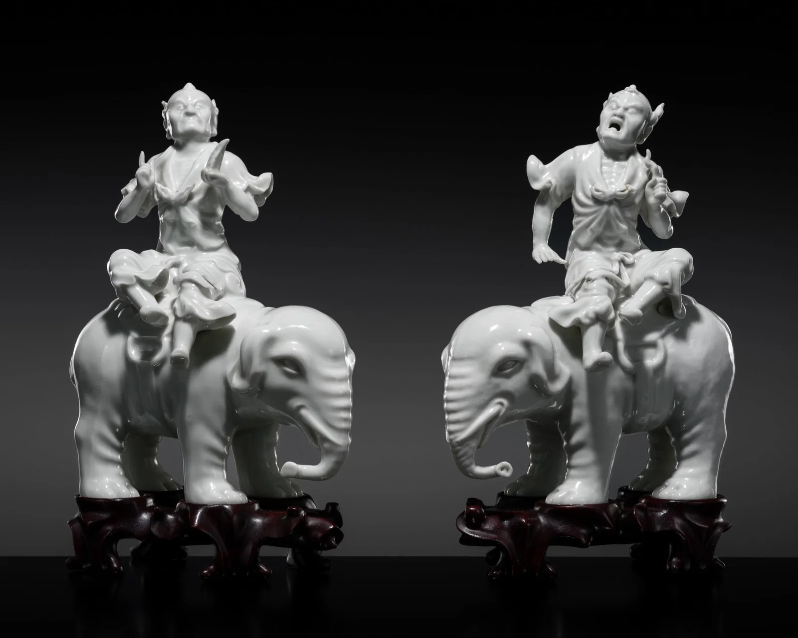 A PAIR OF DEHUA FIGURES OF FOREIGN TRIBUTE BEARERS RIDING ELEPHANTS, QING DYNASTY