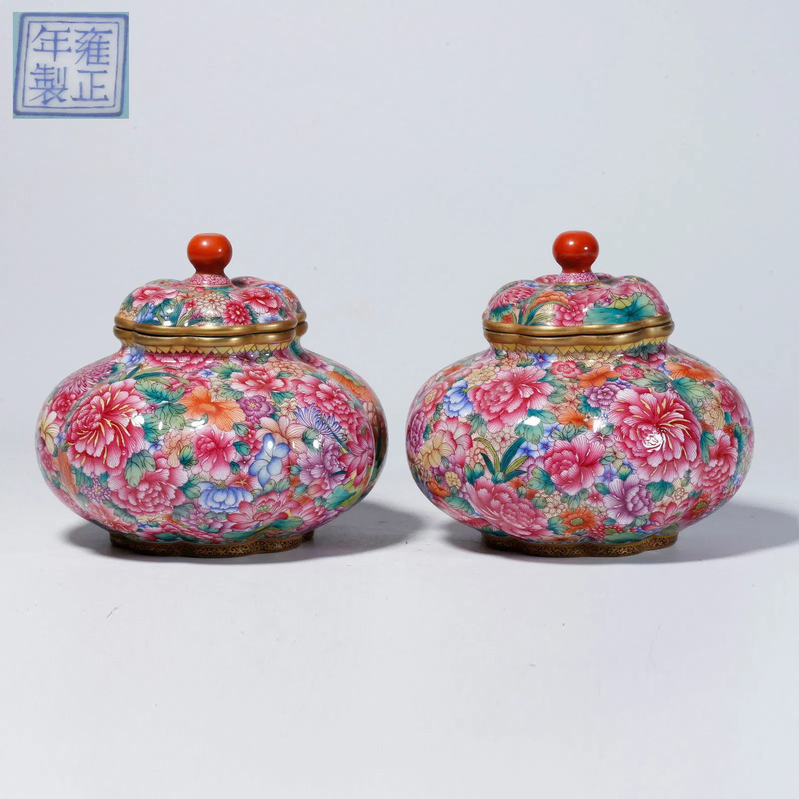 A PAIR OF FAMILLE-ROSE "HUNDRED FLOWERS" LIDDED JARS