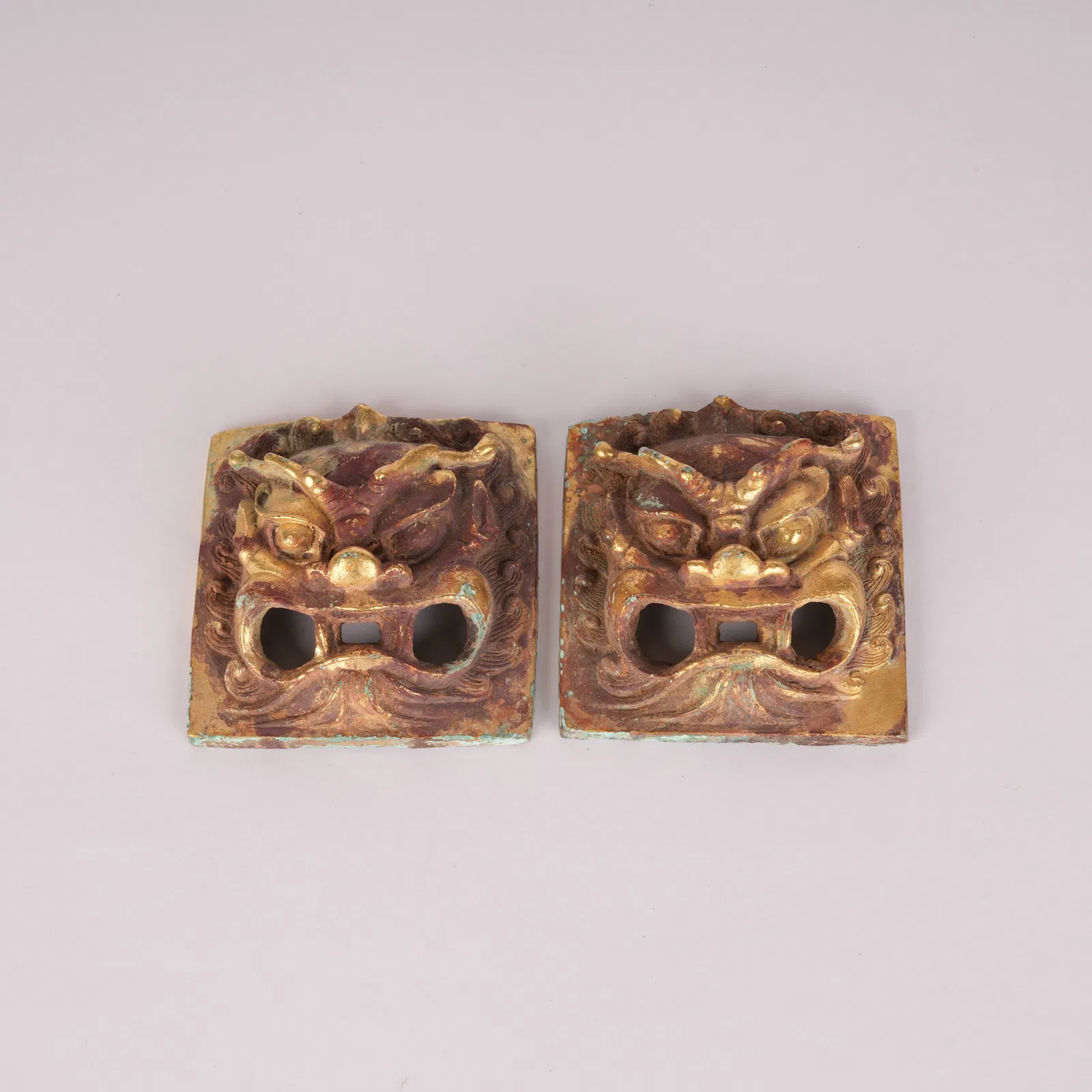 A PAIR OF GILT-BRONZE FINIALS, TANG DYNASTY