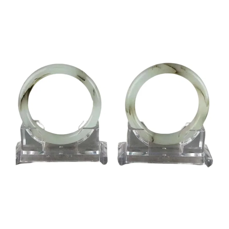 A pair of Hetian jade bangles with floating flower design.