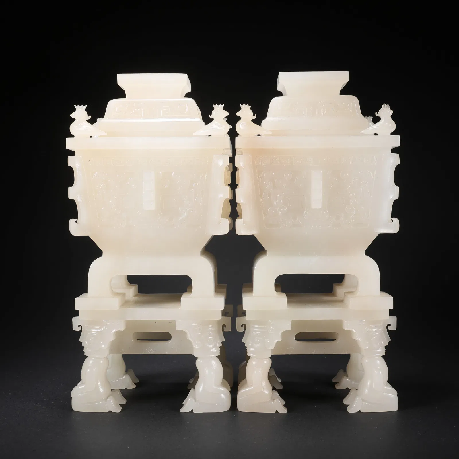 A PAIR OF HETIAN JADE SQUARE DING CENSERS WITH FOUR KNEELING FIGURES AS LEGS AND BIRD MOTIFS, WITH