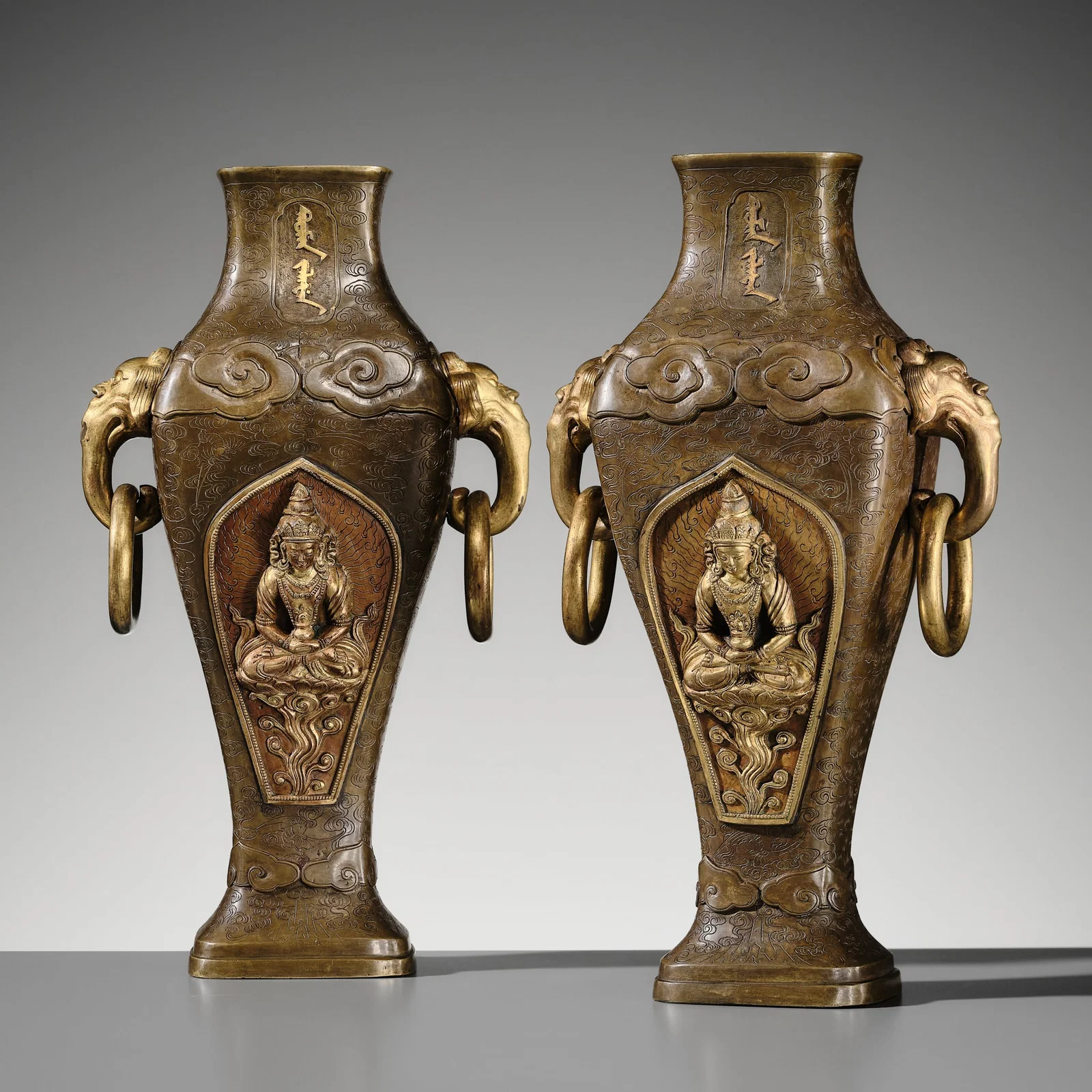 A PAIR OF IMPERIAL PARCEL-GILT BRONZE 'AMITAYUS' ALTAR VASES WITH TIBETAN AND MANCHU SCRIPT,