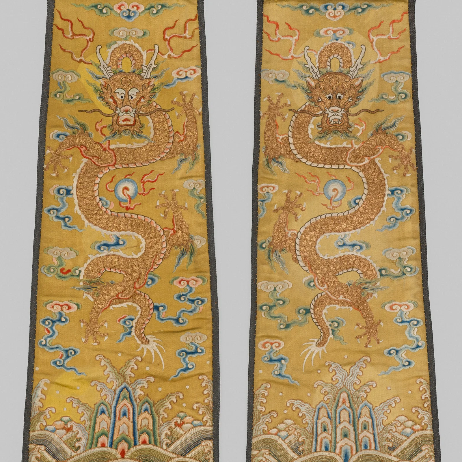 A PAIR OF IMPERIAL SILK EMBROIDERED YELLOW-GROUND 'DRAGON' PANELS, 18TH CENTURY