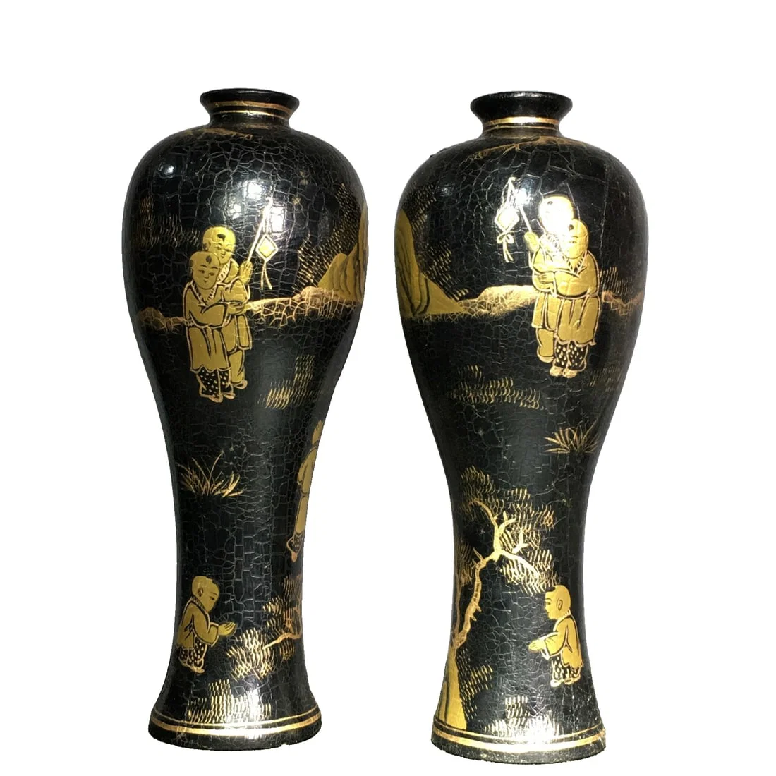 A pair of lacquerware vases with gold-painted floral designs on a wooden base.