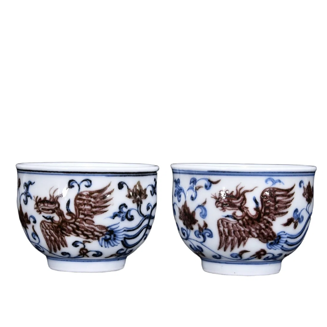 A pair of Ming Xuande blue and white porcelain cups with underglaze red phoenix pattern.