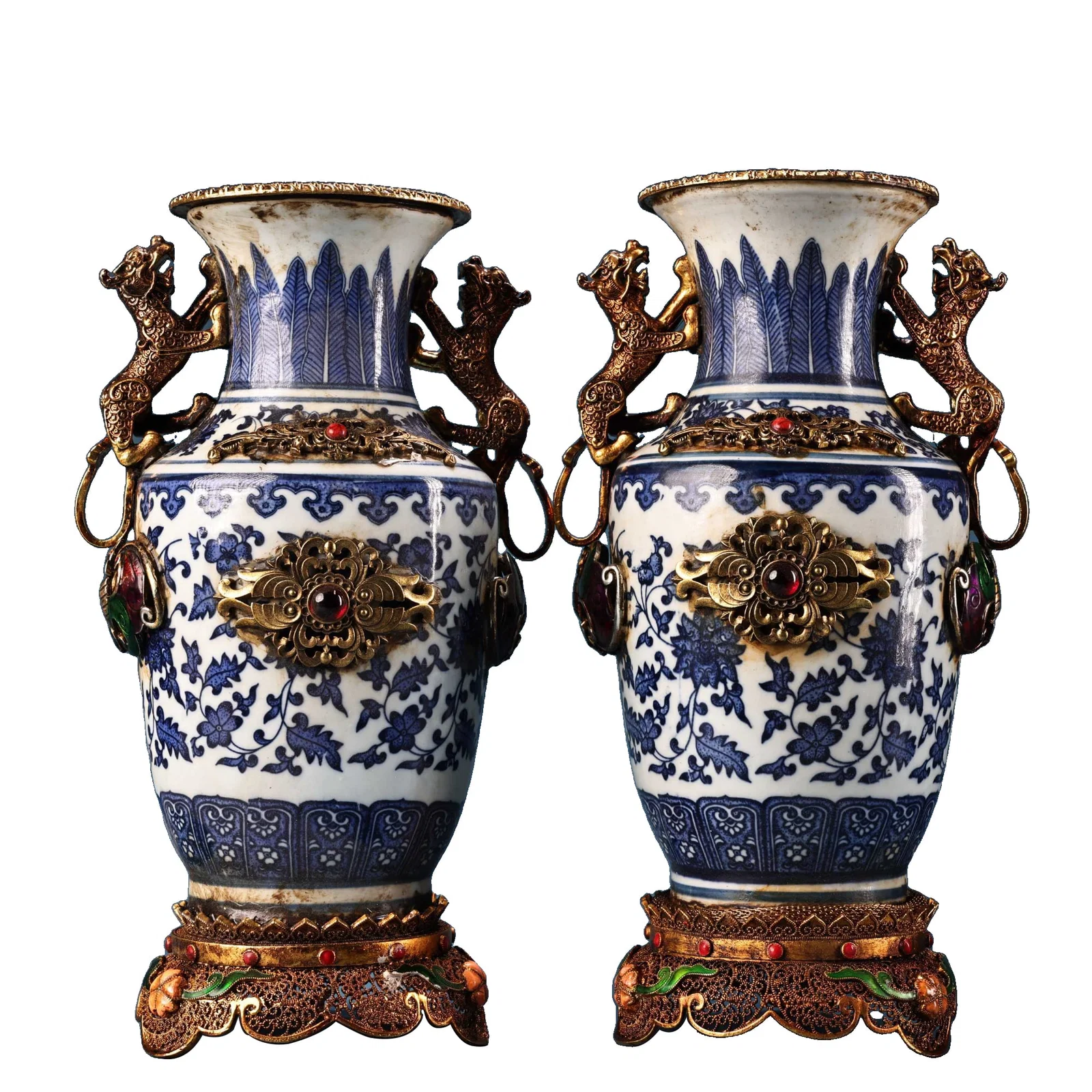 A pair of porcelain vases with gold filigree craftsmanship.