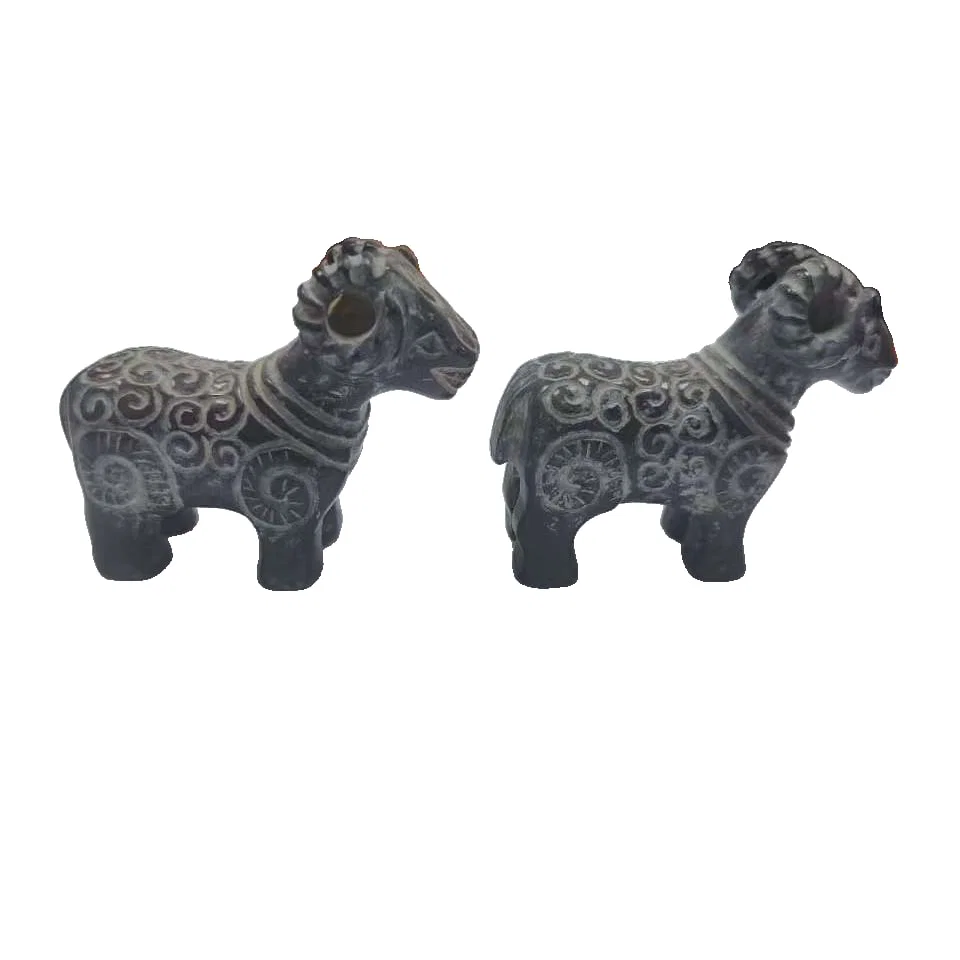 A pair of sheep-shaped carved ornaments