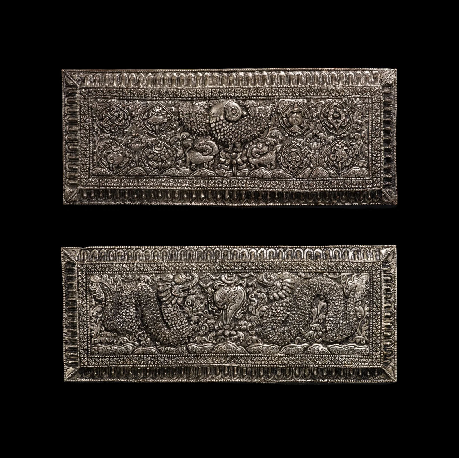 A PAIR OF SILVER-MOUNTED AND FINELY PAINTED WOOD SUTRA COVERS, TIBET, 17TH CENTURY