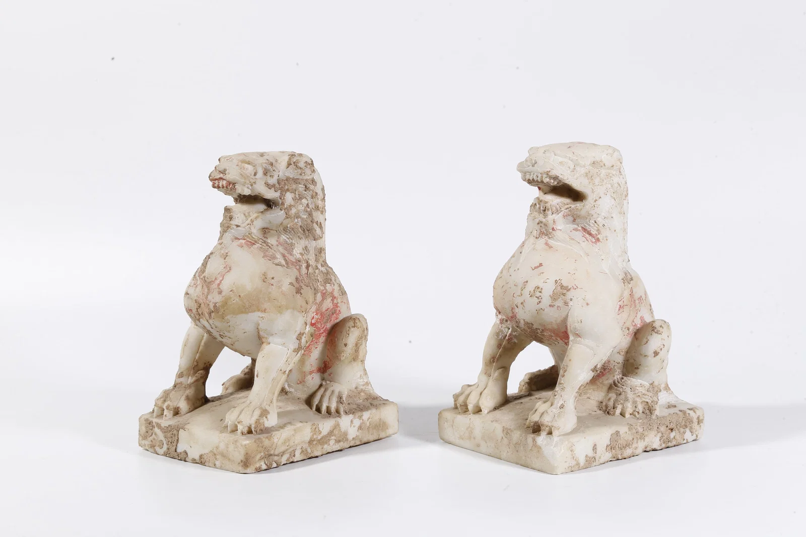 A PAIR OF WHITE MARBLE LION-FORM ORNAMENTS
