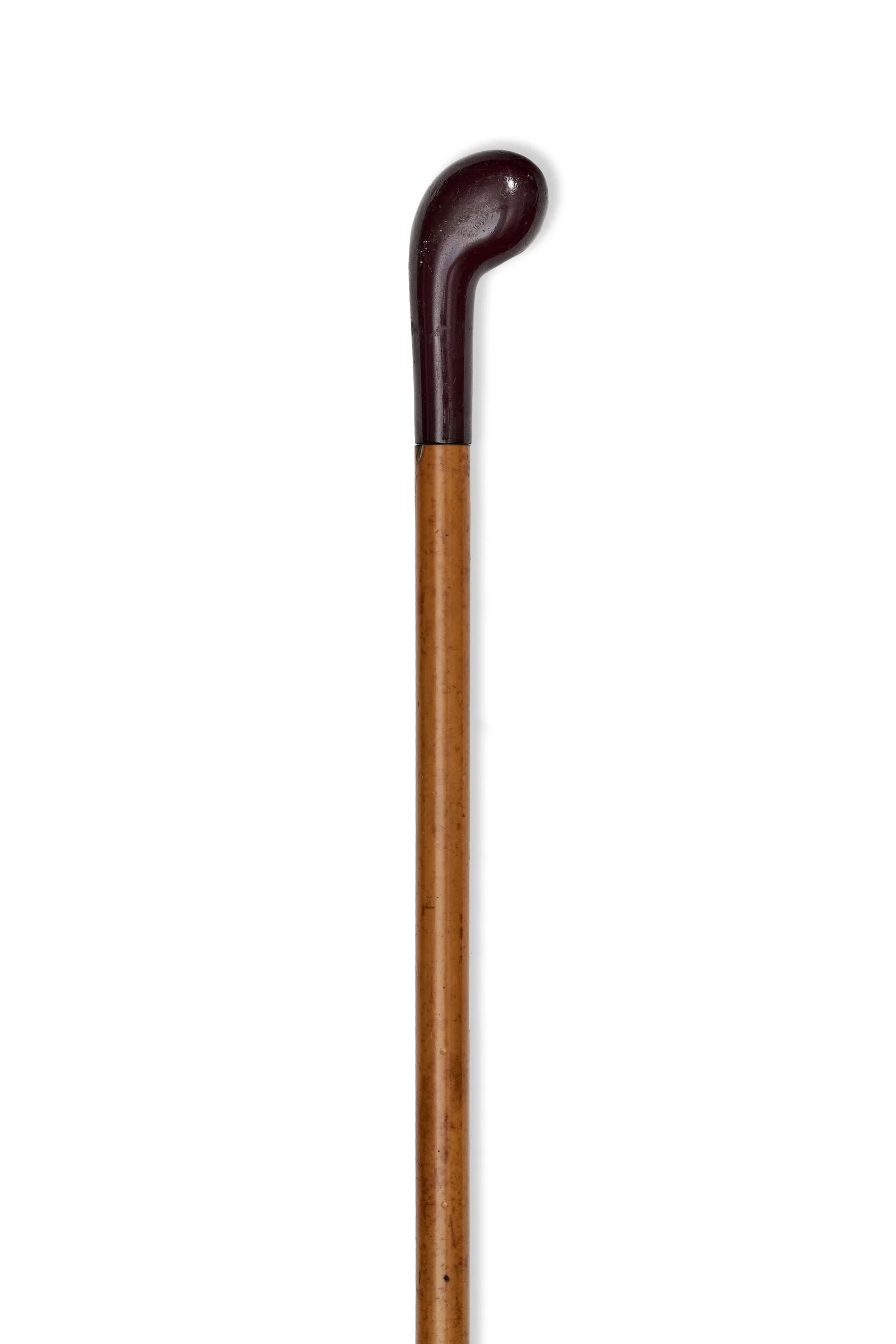 A PALM GRIP WALKING CANE WITH CHERRY AMBER HANDLE AND HARDWOOD SHAFT
