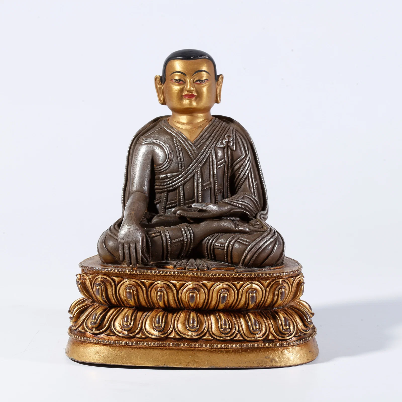 A PARTIAL GILT BRONZE STATUE OF A LAMA