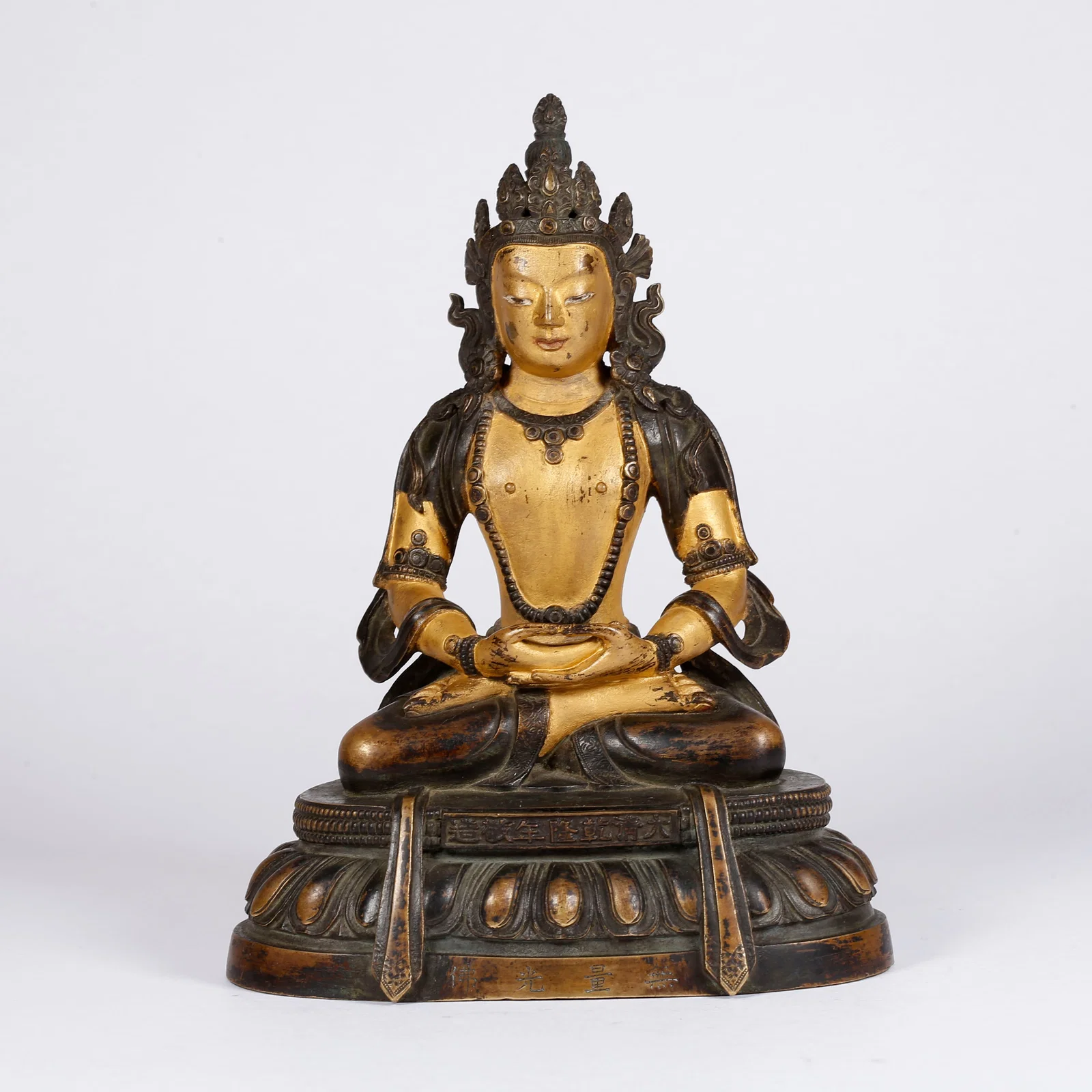 A PARTIALLY GILT BRONZE MEDICINE BUDDHA STATUE