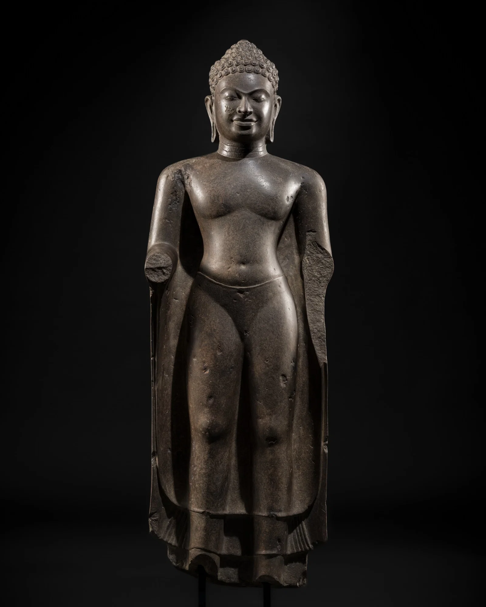 A POLISHED SANDSTONE FIGURE OF BUDDHA, MON DVARAVATI PERIOD, 7TH-9TH CENTURY