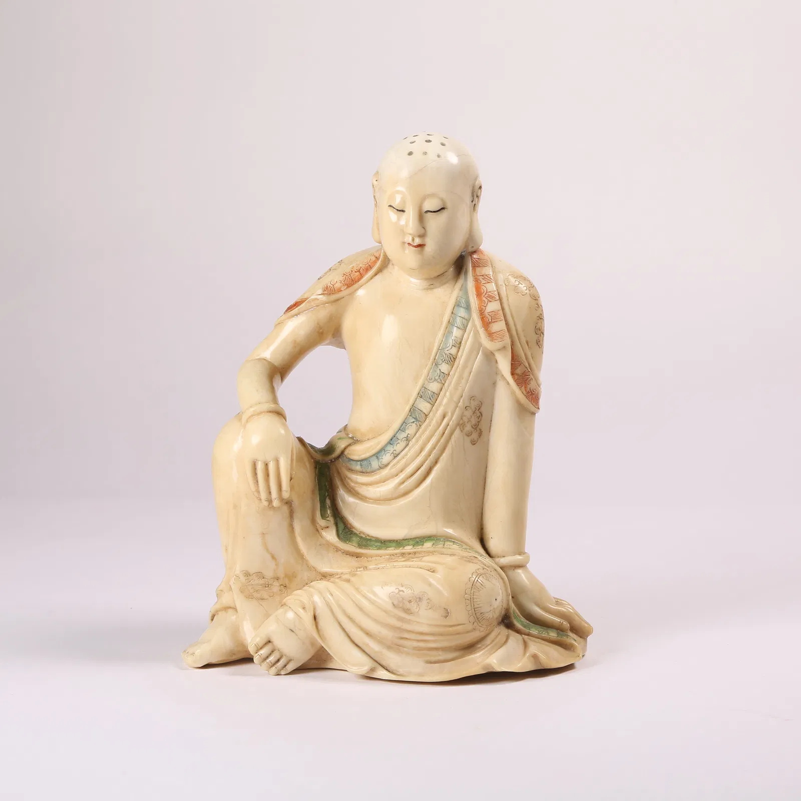 A POLYCHROME SHOUSHAN STONE SEATED ARHAT