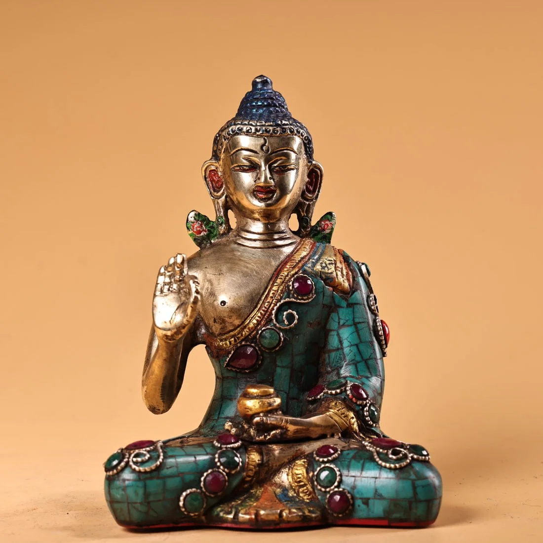 A pure copper, painted, gilded, and gem-inlaid statue of Vairocana Buddha, crafted in Nepal and