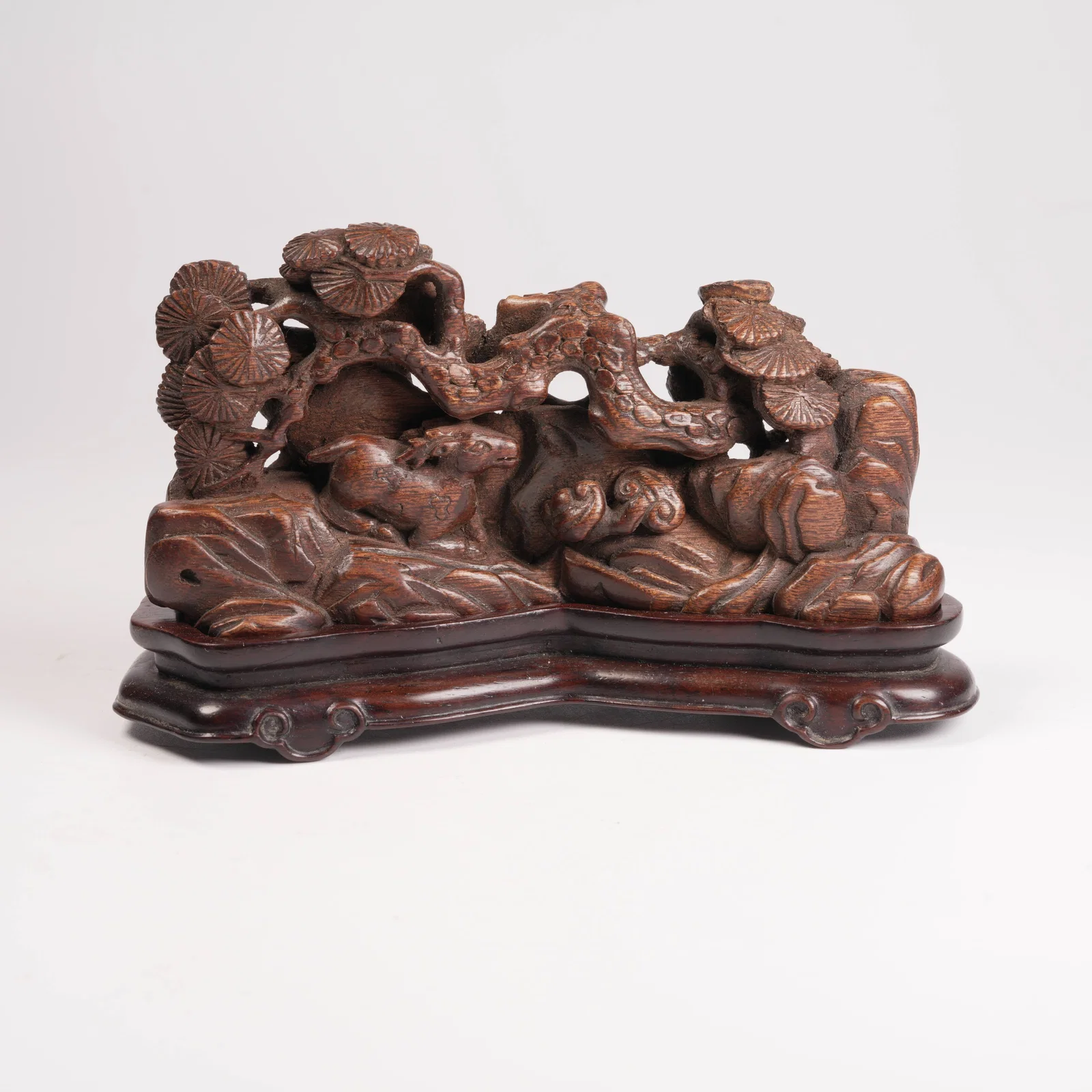 A QINAN WOOD MINIATURE ORNAMENT WITH PINE-AND-DEER MOTIF