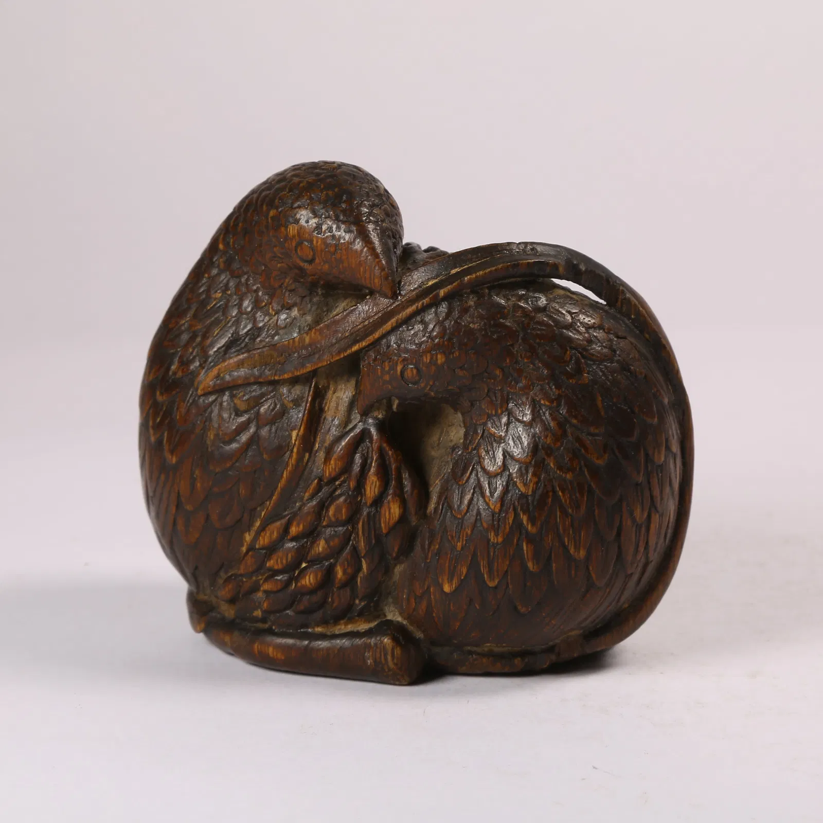 A QINAN WOOD "PEACE AND PROSPERITY" FIGURINE