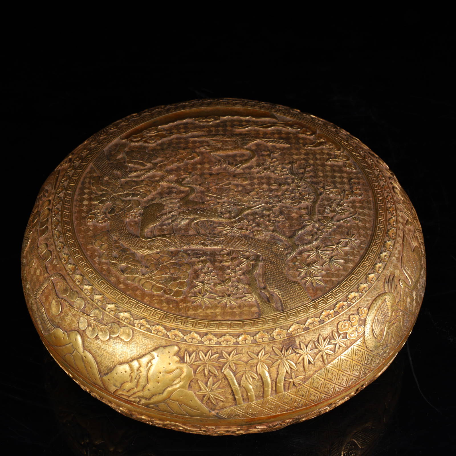 A Qing Dynasty copper gilt crane deer with a spring pattern lid box